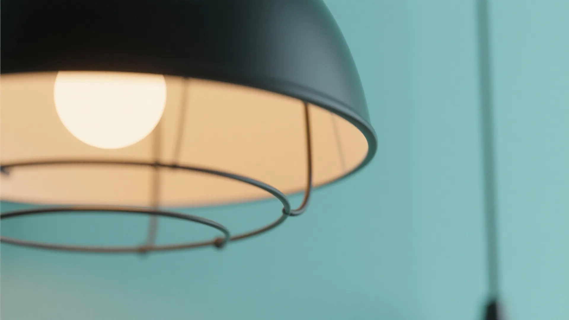 Black pendant lamp on mint wall