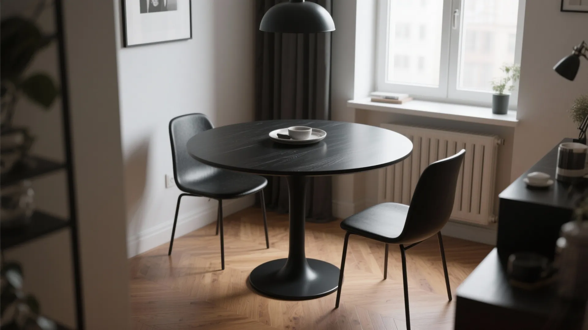 2. Black pedestal table to open tight spaces