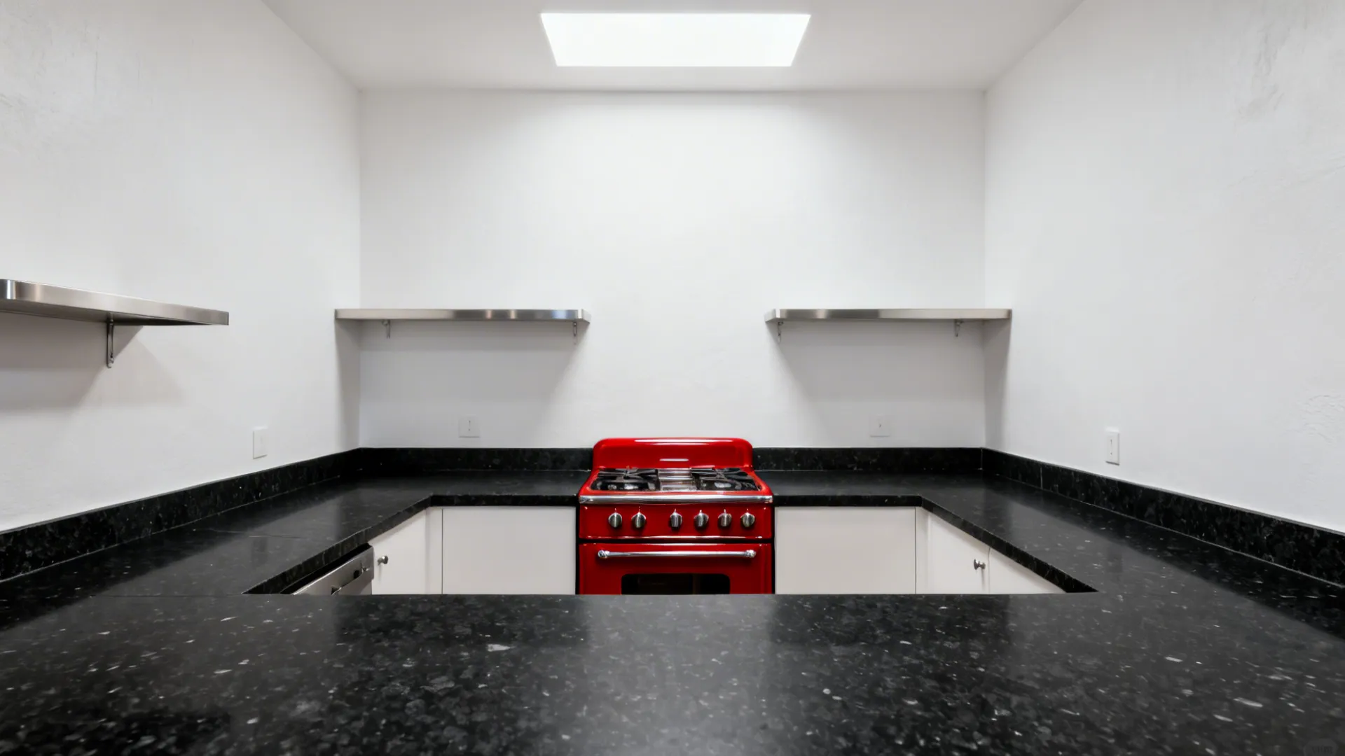 Black quartz counters with white walls and a red statement appliance