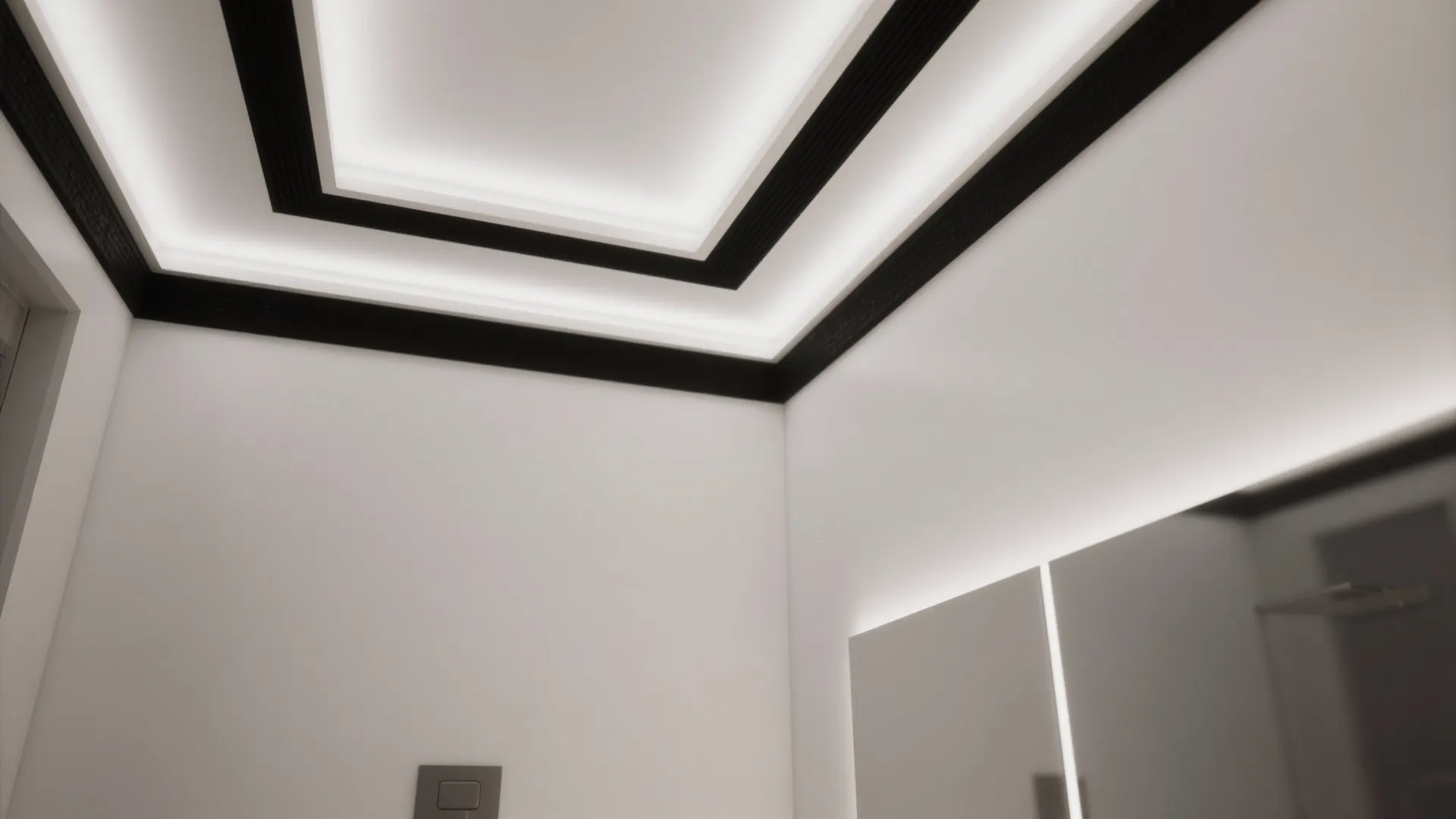 Modern ceiling design featuring black trim and bright recessed strip lights in a white room