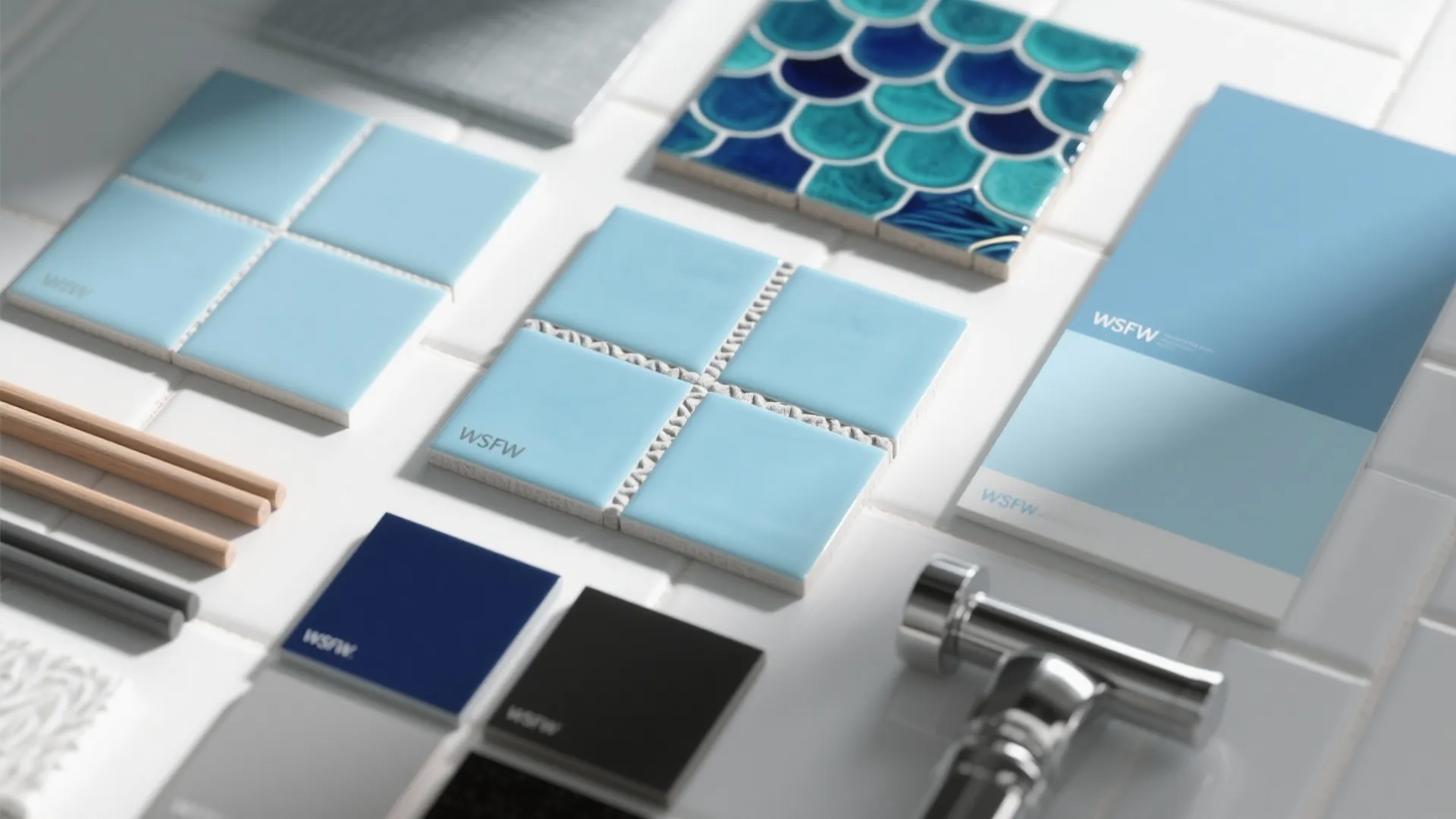 Flat lay of blue tile samples, grout sticks, and finishes for small bathrooms.