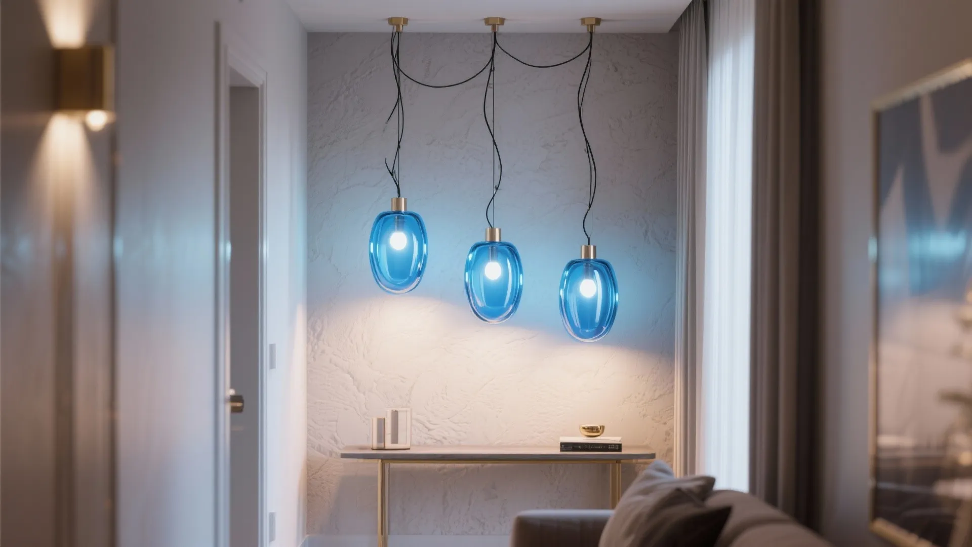 Three blue glass ceiling light fixtures hanging over a narrow console table in a hallway