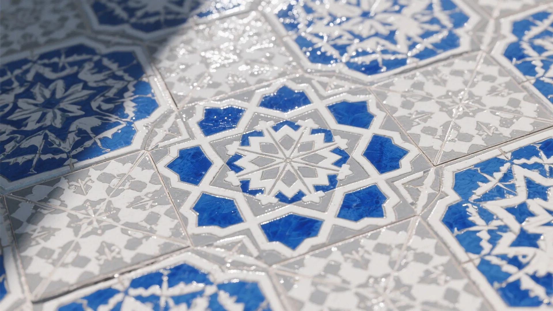 Close up of blue and white patterned floor tiles with a geometric star shape design