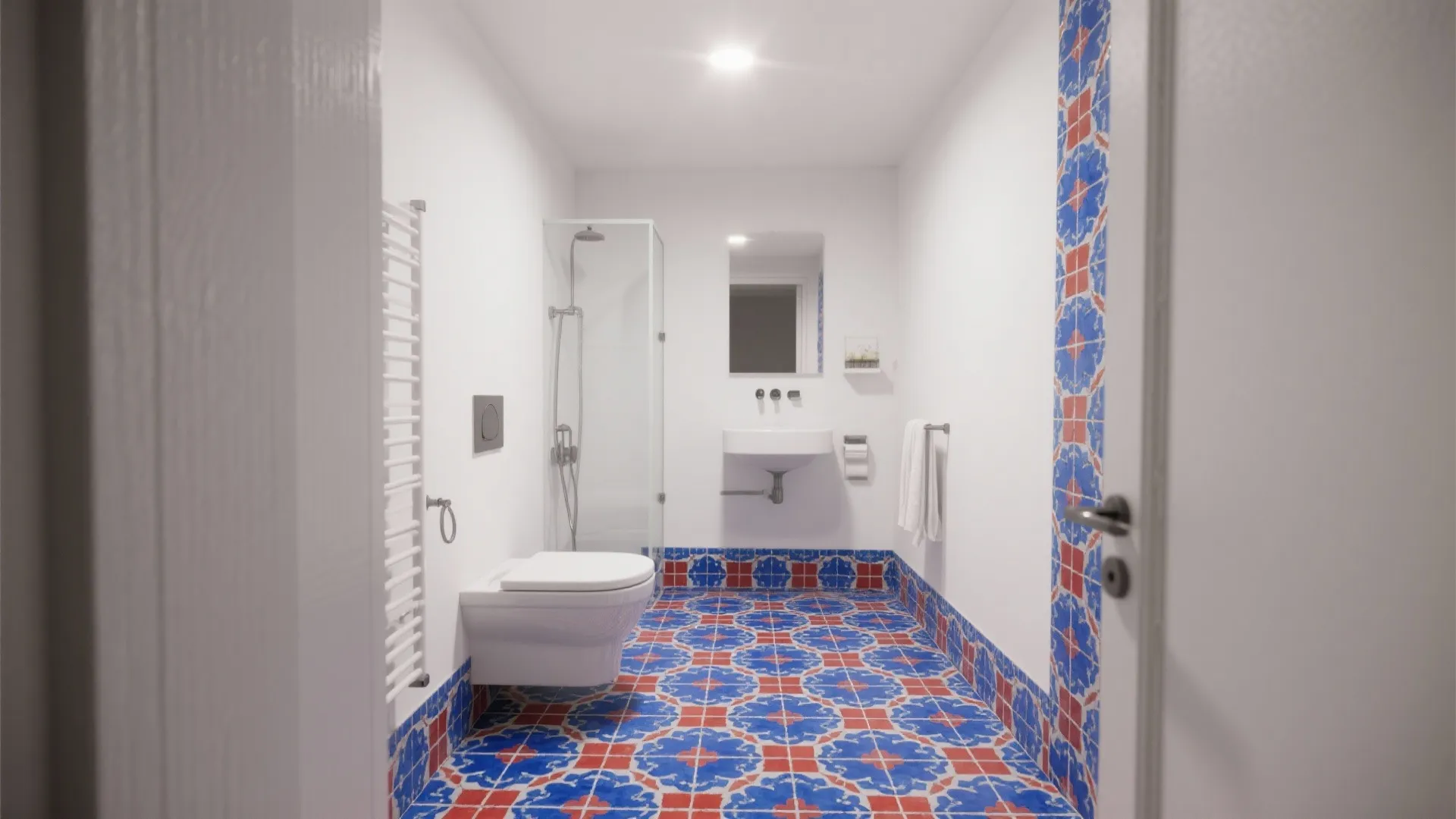 White bathroom featuring blue and red mosaic tile floor with white toilet sink and shower