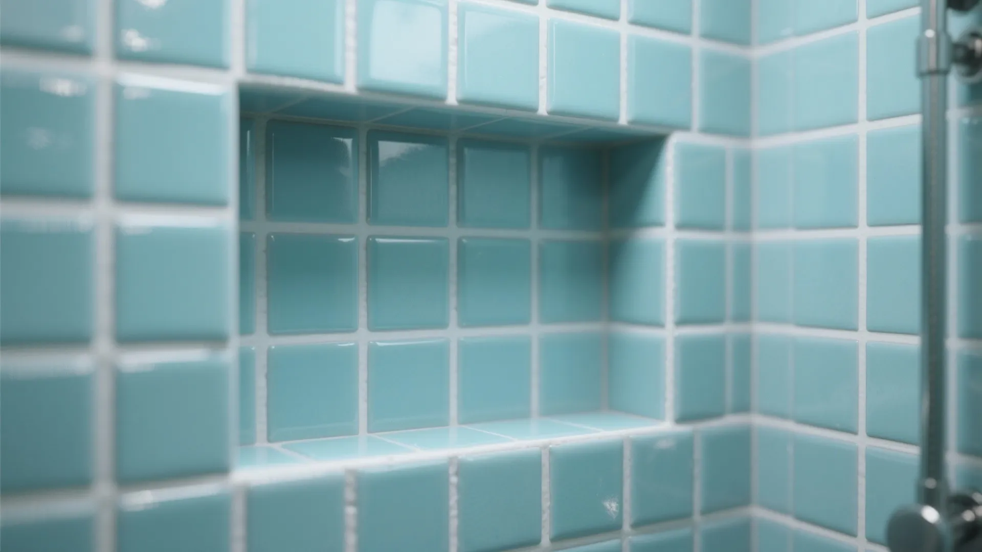 Detail of light blue square wall tiles in a bathroom shower with a built in shelf