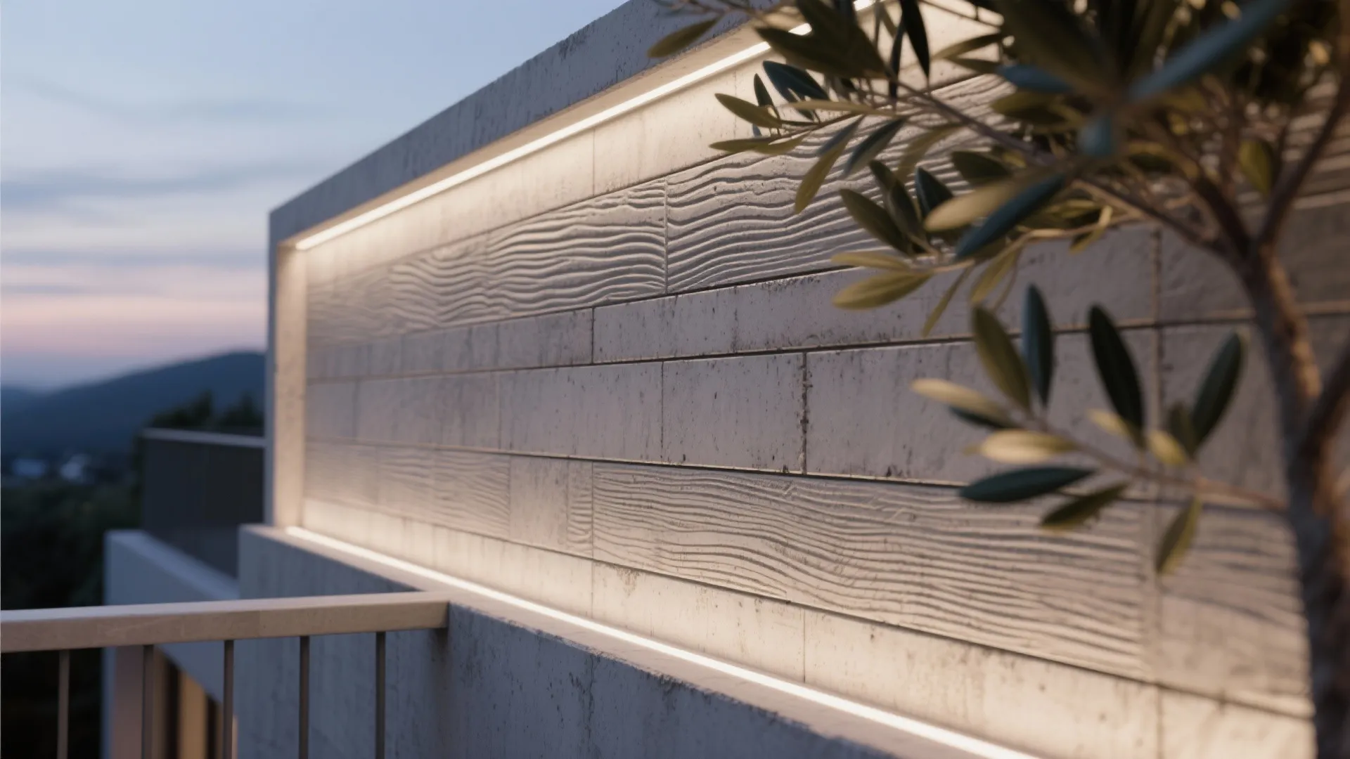 Concrete wall showing wood texture and glowing light strips beside an olive tree during sunset