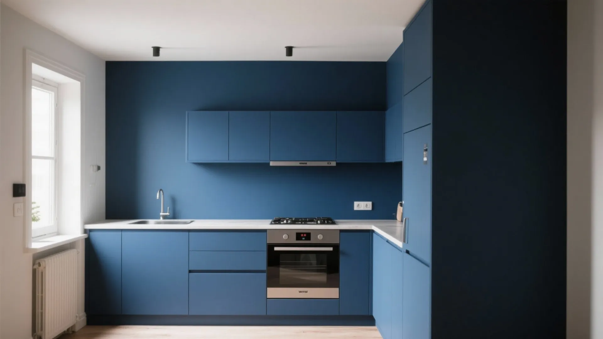 Modern blue kitchen with dark cabinets white countertop silver oven sink and small ceiling light