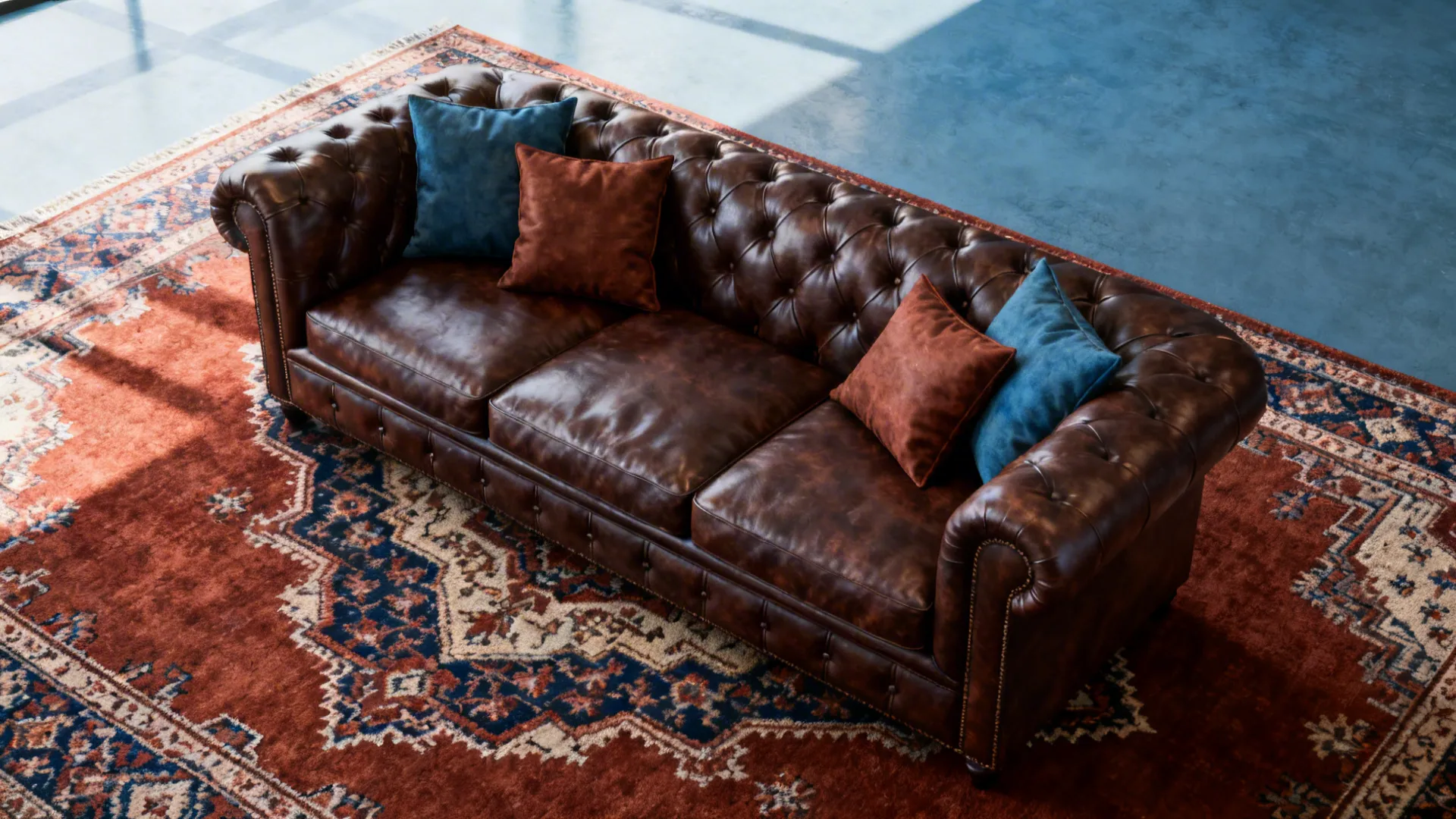 Dark brown leather sofa placed on a bold patterned rug with warm rust and muted blue tones