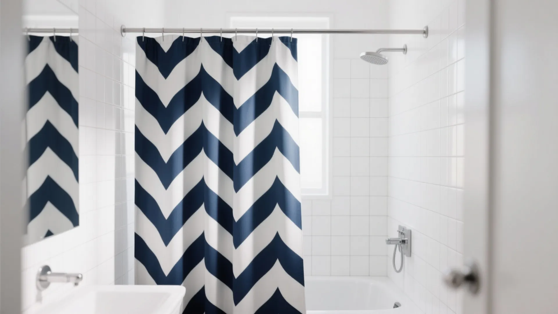Modern bathroom featuring blue and white chevron shower curtain silver shower head and white tiles