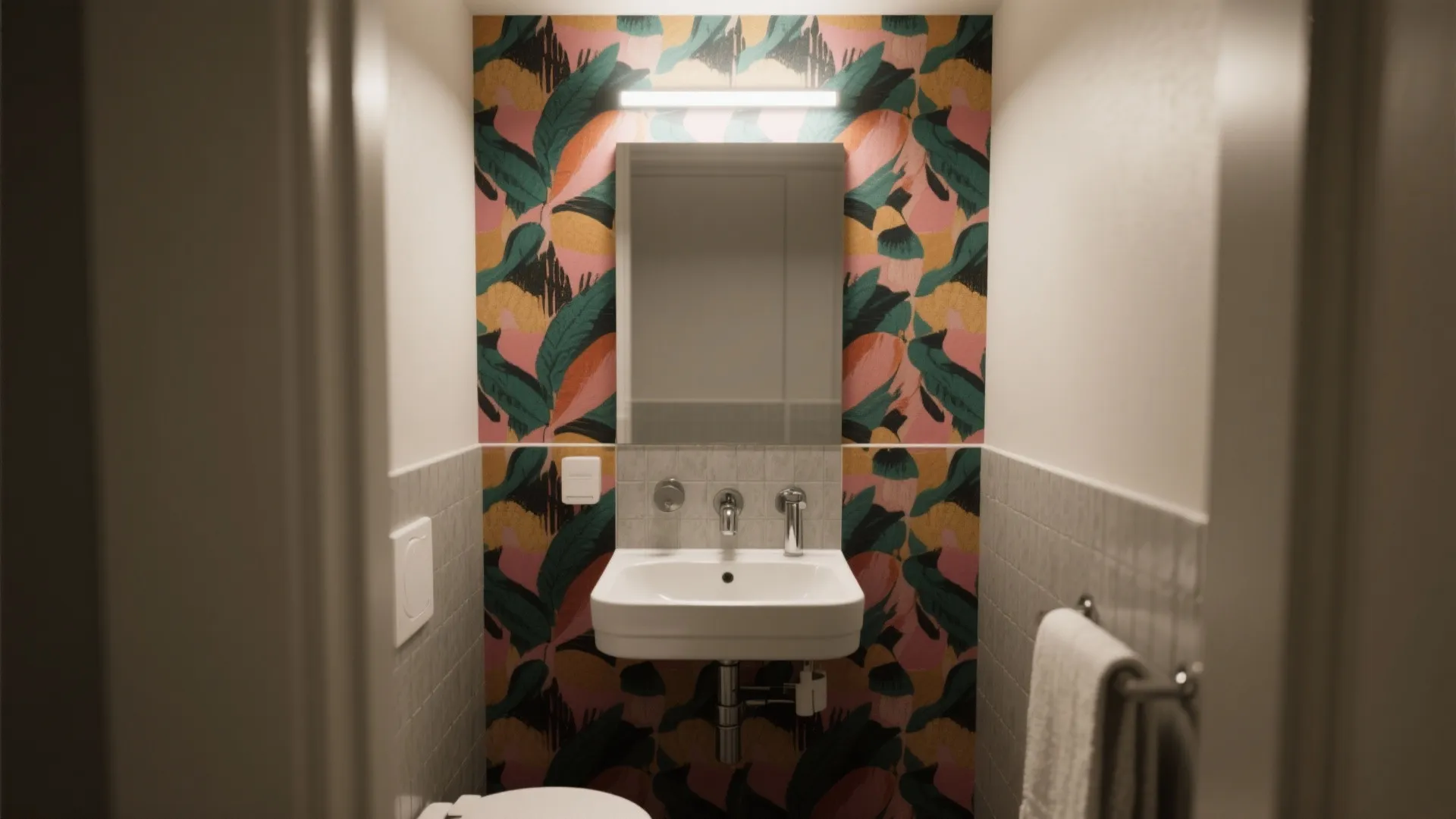 Small bathroom featuring colorful tropical leaf wallpaper a simple white washbasin and a modern mirror