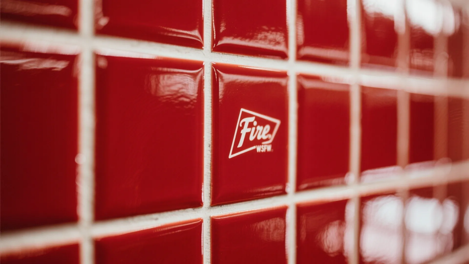 Glossy fire-engine red subway tiles with white grout in a bathroom