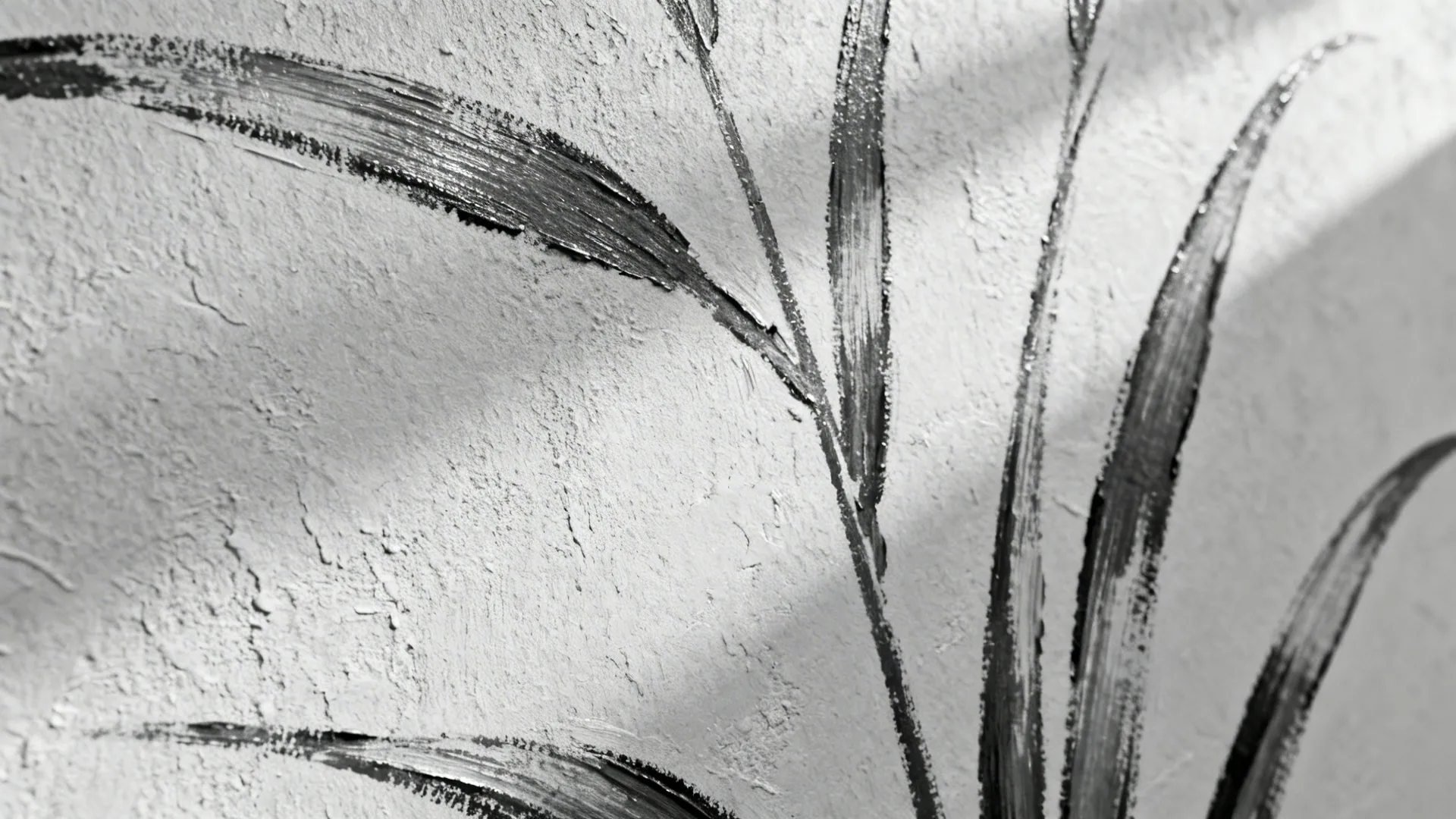 Black and white close up of a textured wall with painted leaf lines and soft shadows