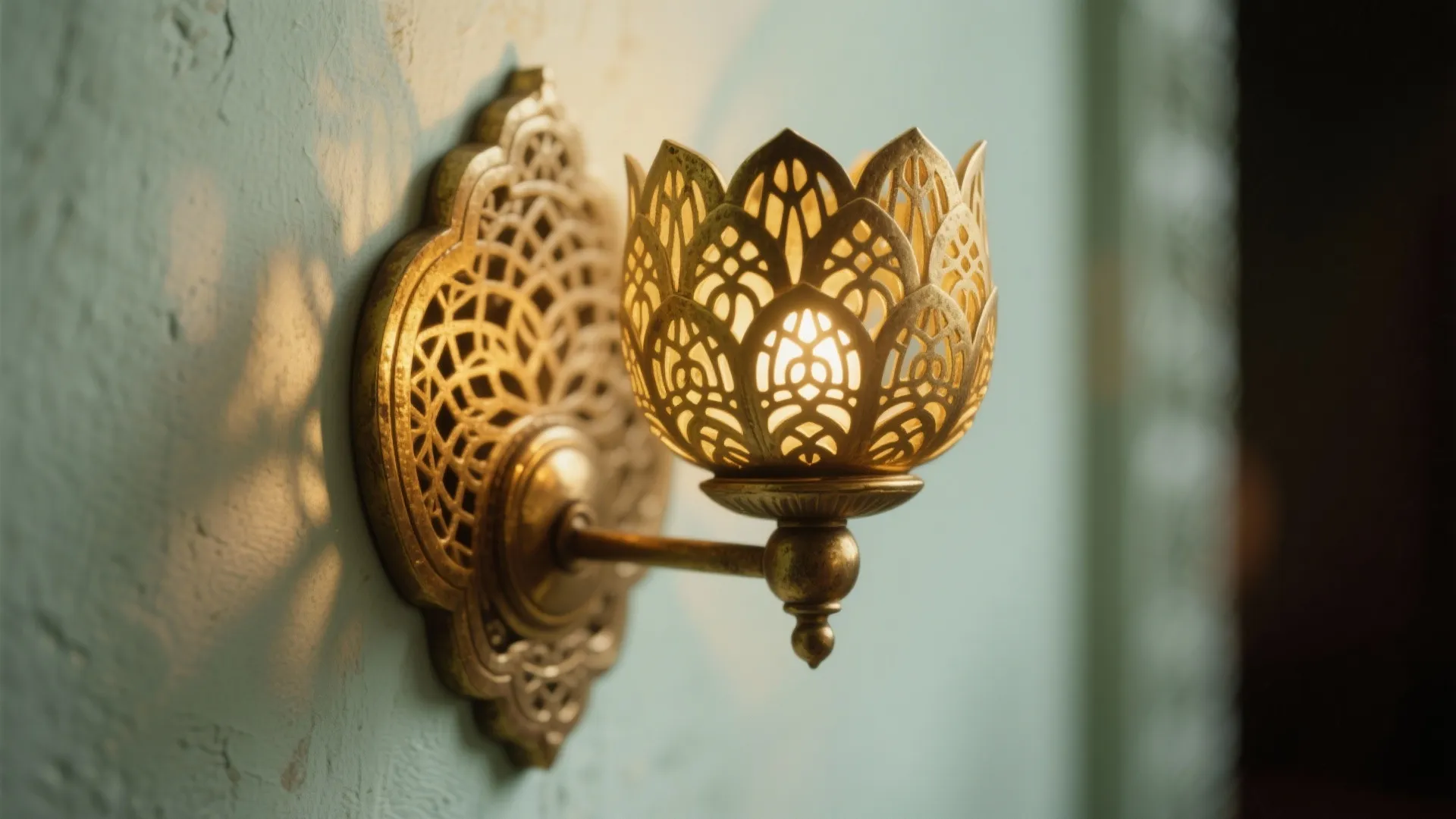 Brass sconces with cutwork motifs