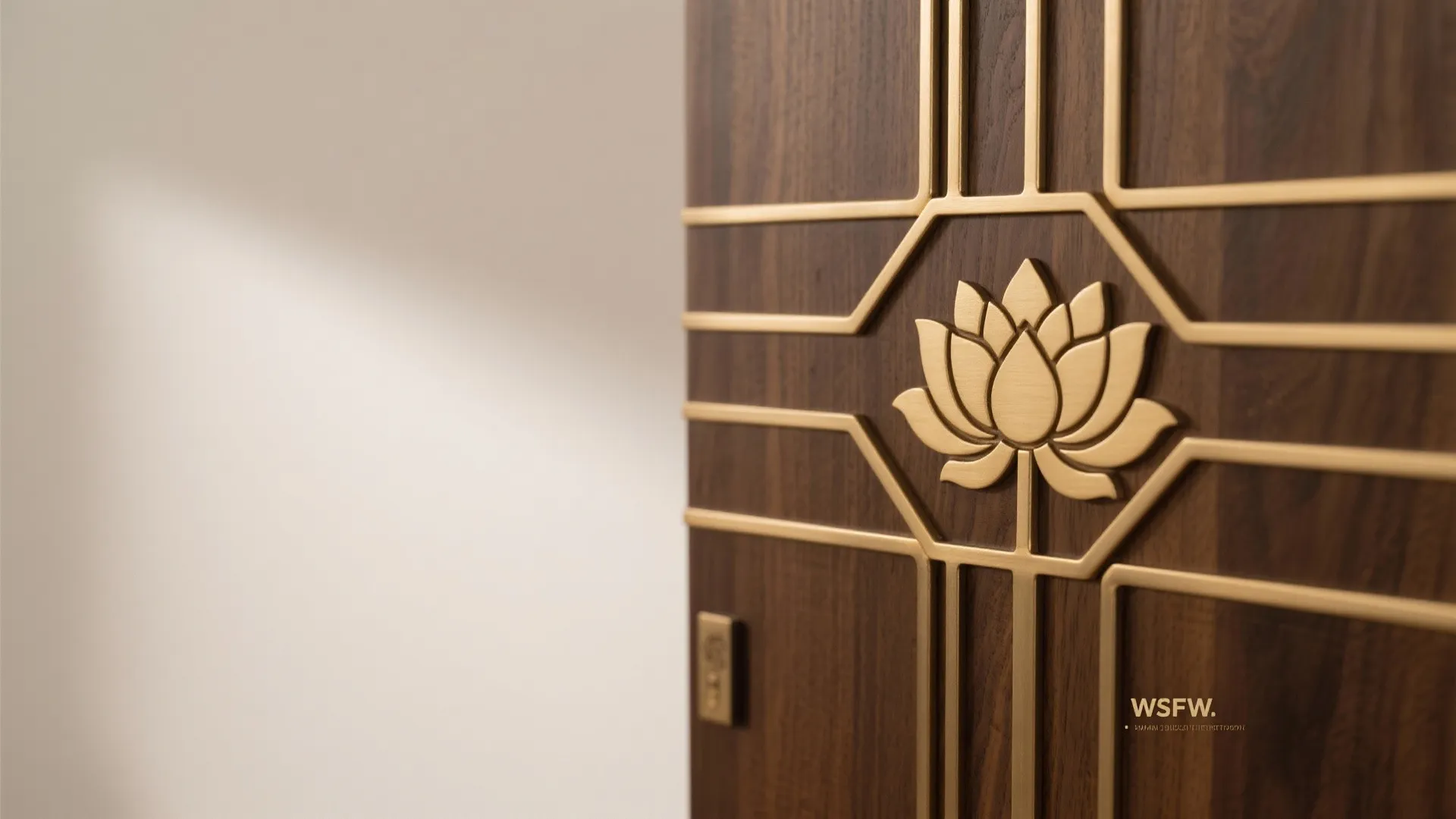 Close up view of dark wood cabinet door with golden metal flower pattern and line details