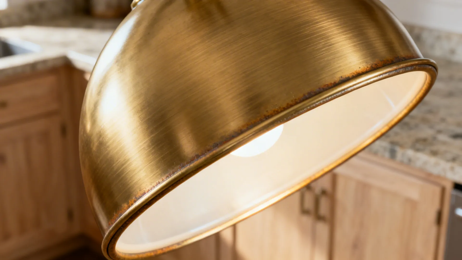 Warm metal pendants over the island