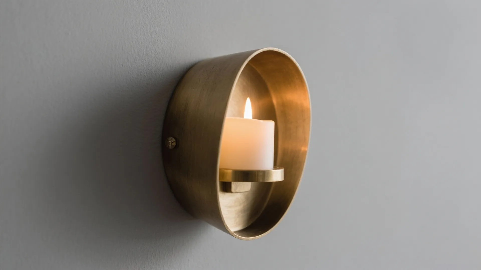 1) Sculptural metal sconces with warm finishes