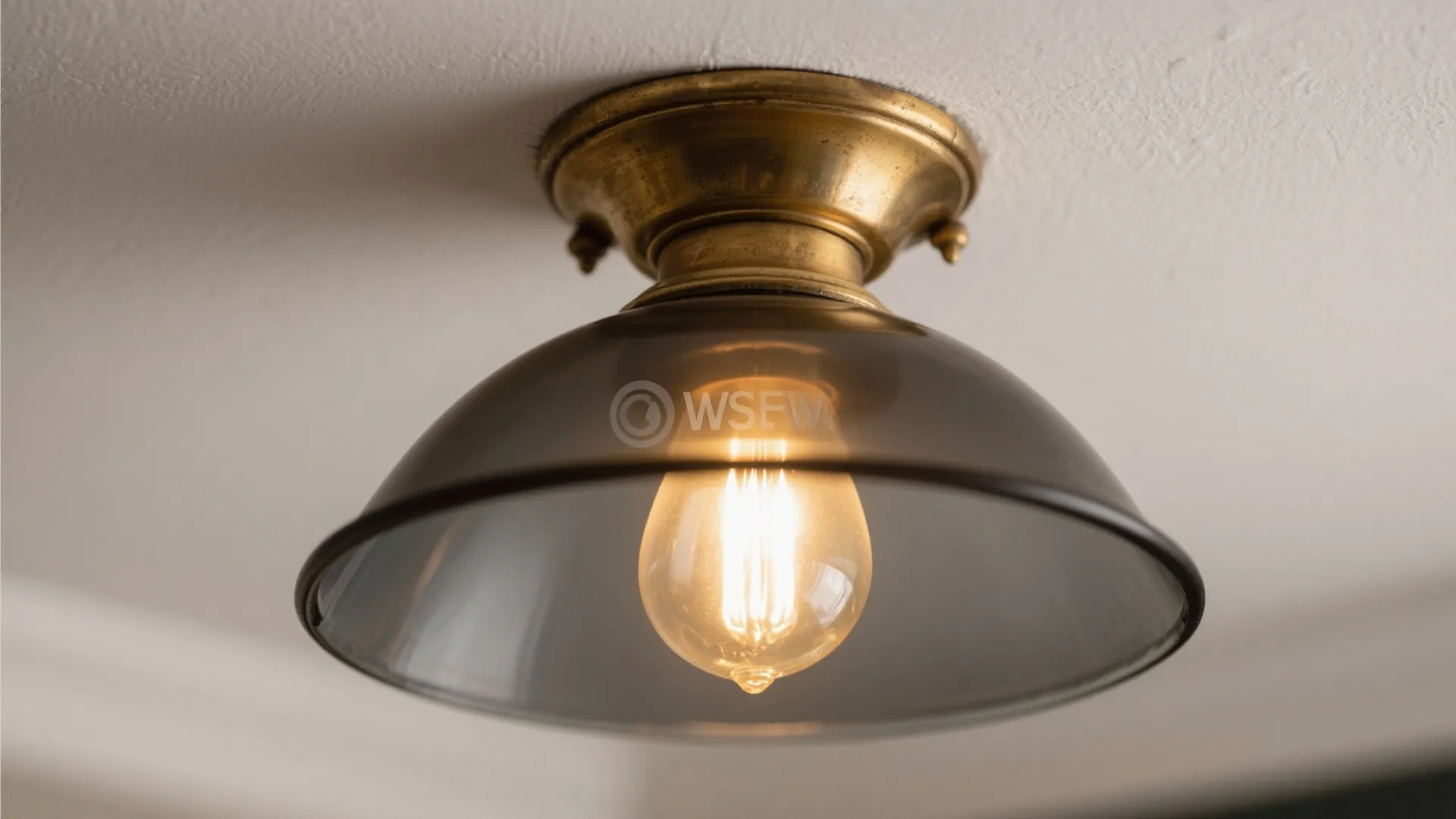 Antique brass and smoked glass lighting