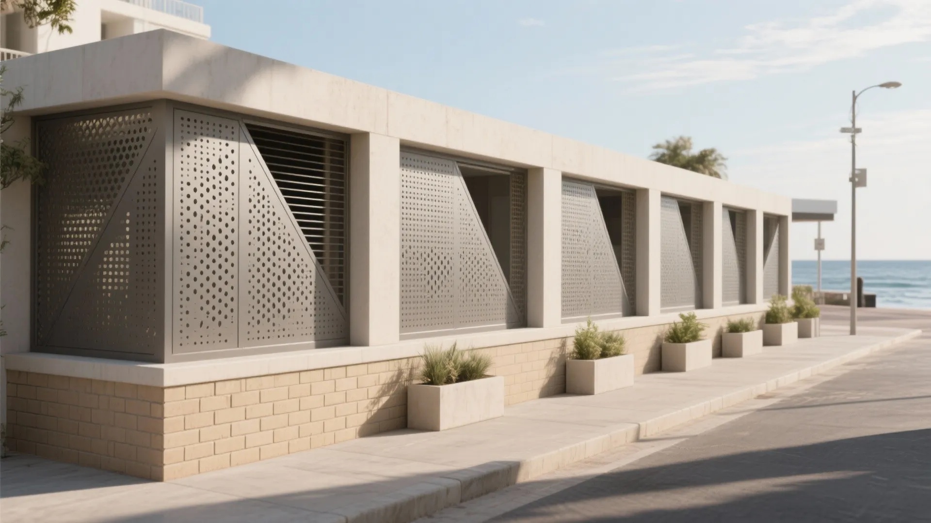 Modern outdoor wall with metal breeze screens and brick base along a sunny coastal sidewalk
