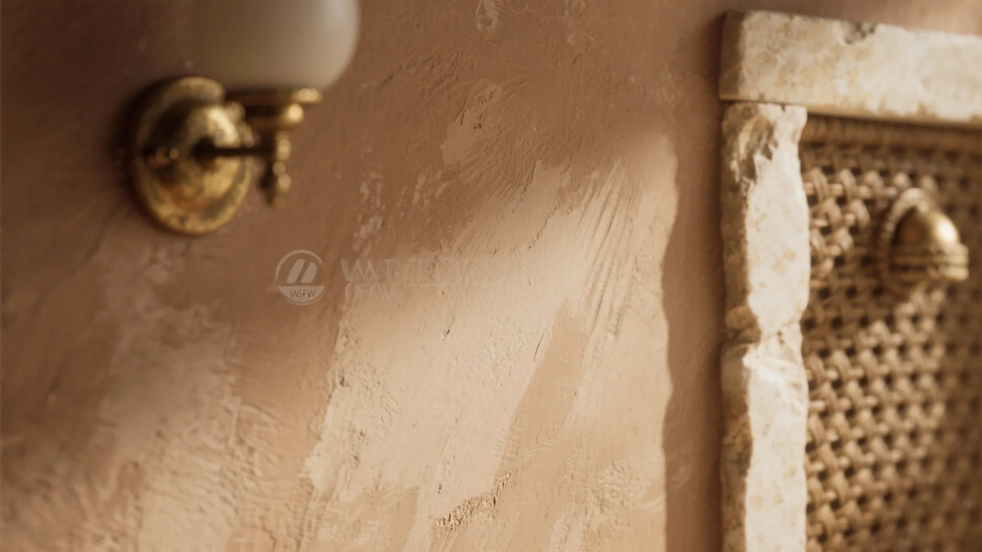 Close up of textured brown wall with gold wall light and stone frame near woven screen