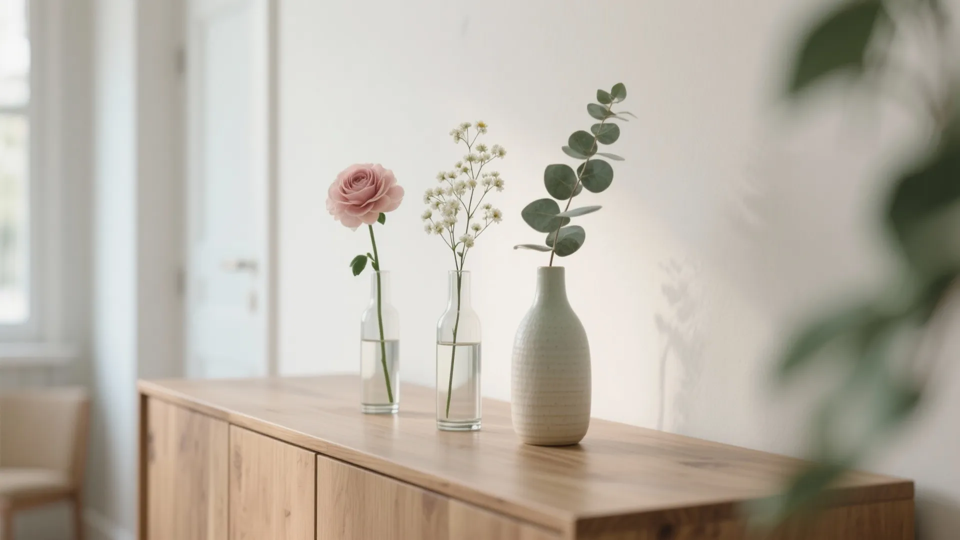 Minimalist floral vignettes on shelves and sideboards