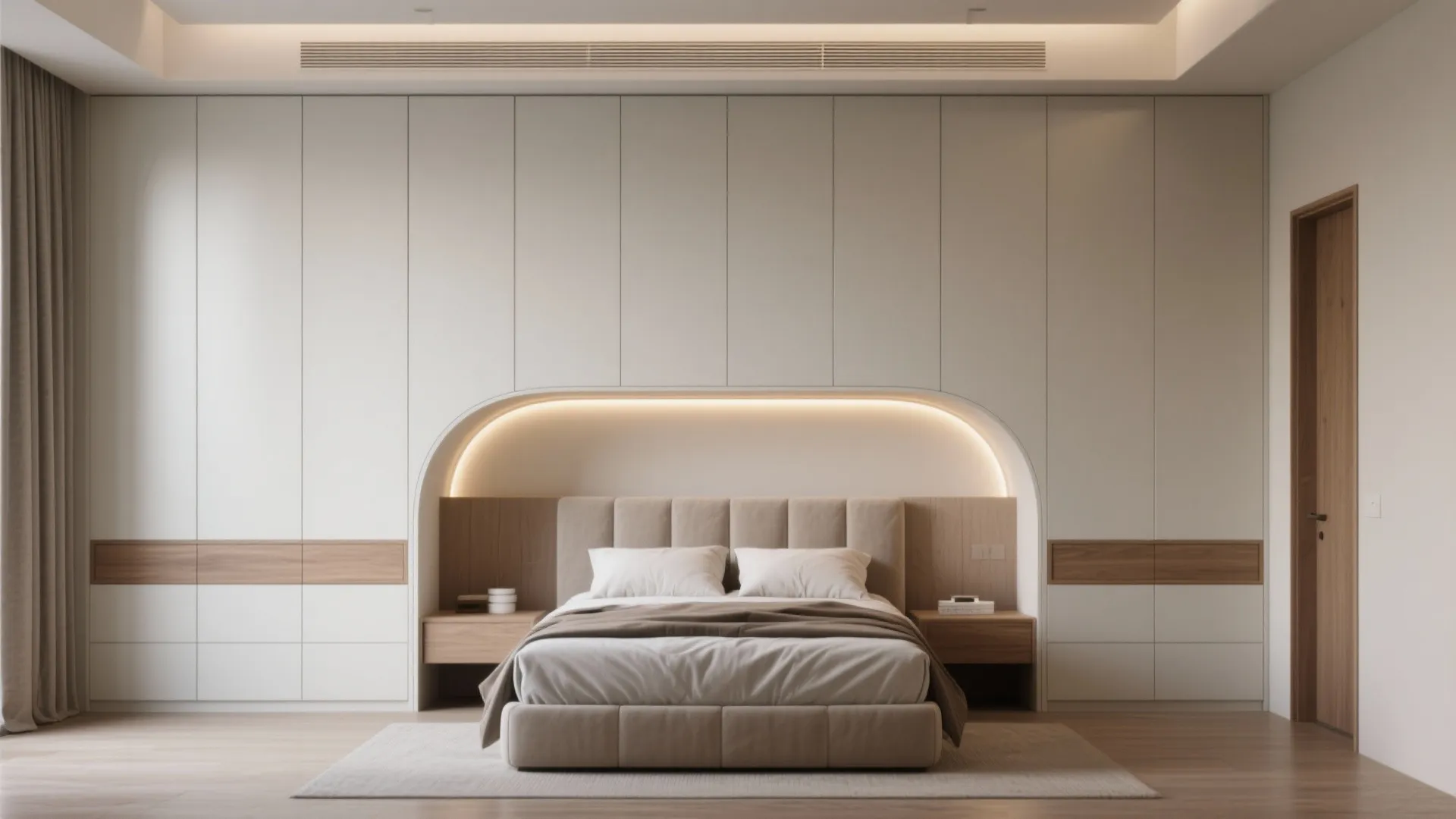 Built-in wardrobe wall with a recessed bed niche, integrated lighting and clean joinery in a small bedroom.