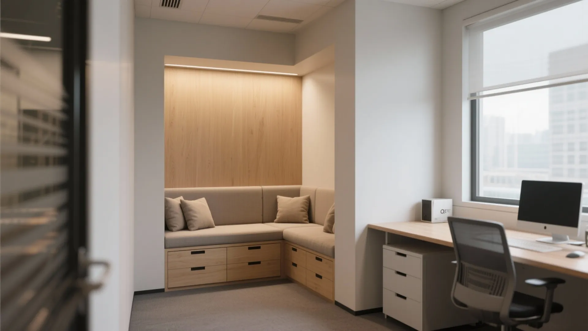 Modern office corner featuring built in sofa wood wall panel drawers and a computer desk