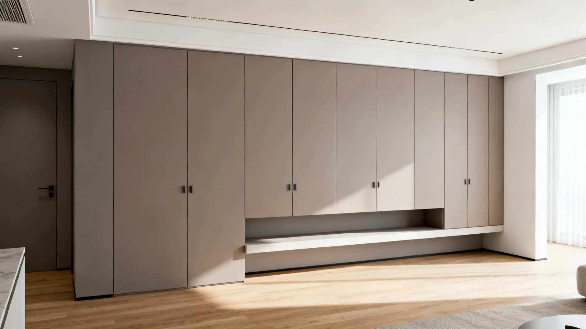 Soft gray flat-front built-in cabinets blend into the living room wall.