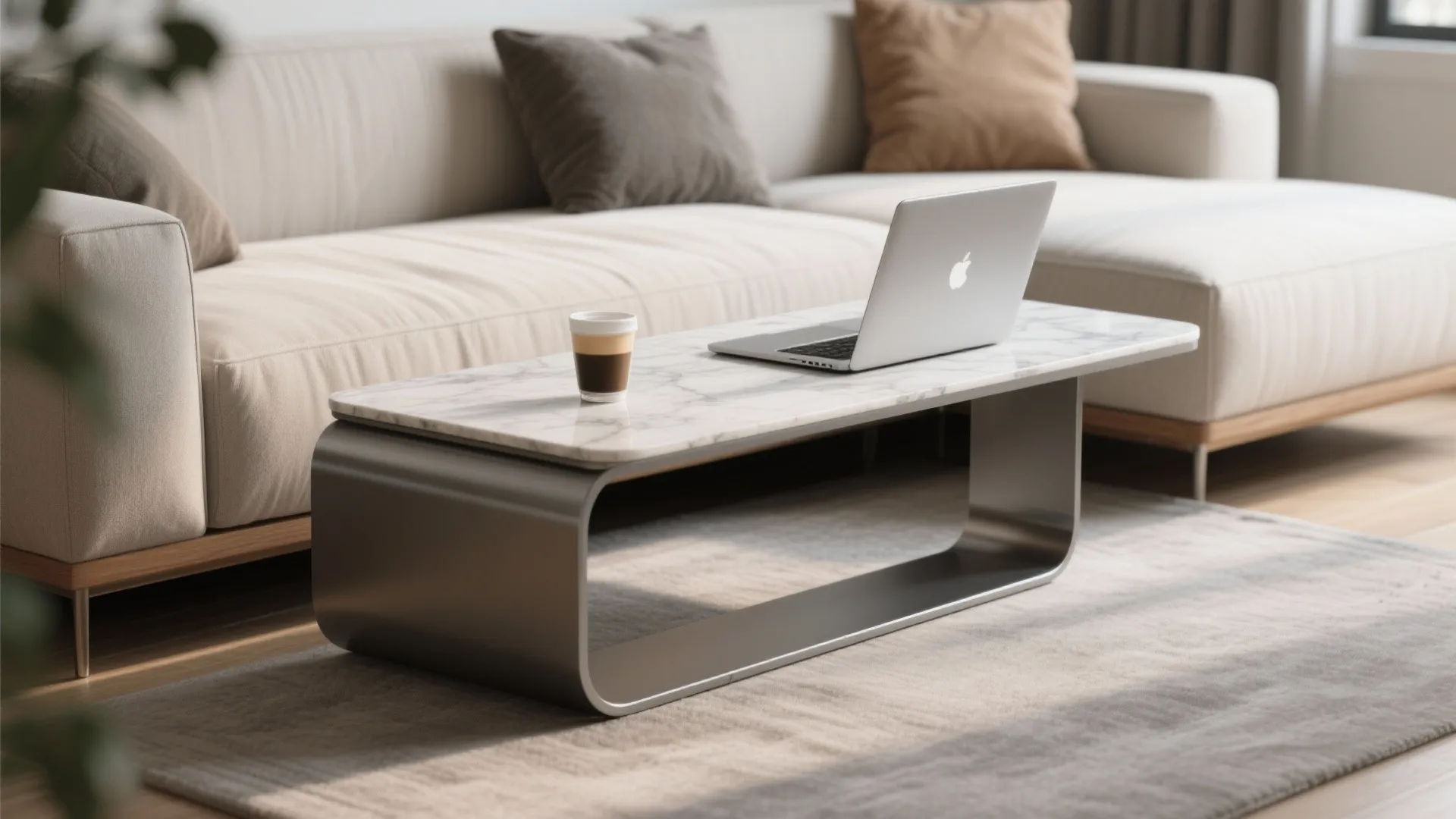 Modern marble top coffee table with a cup and laptop sitting on a grey rug