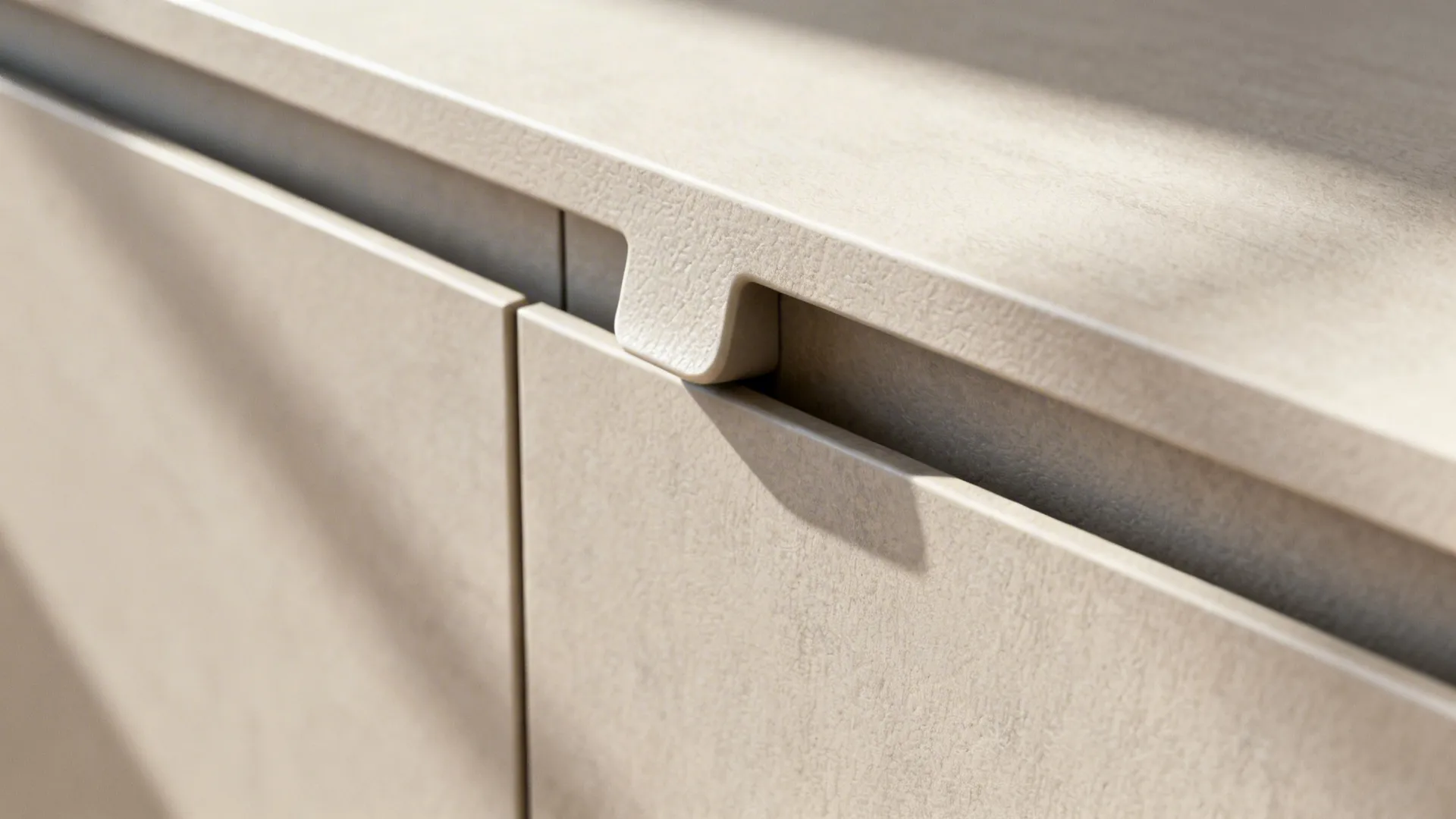 Macro of matte handleless cabinet edge with textured laminate finish.