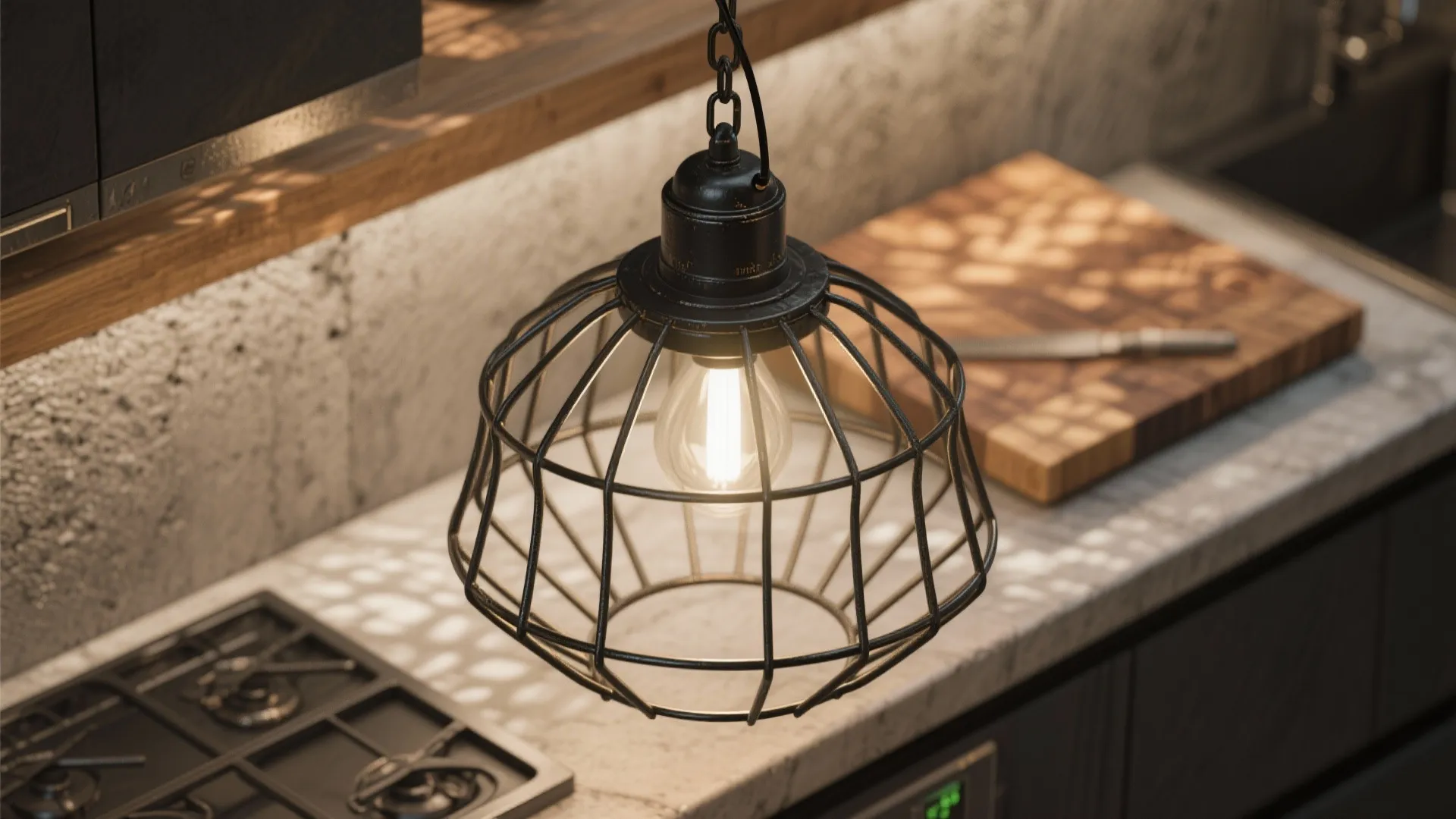 Close-up of an industrial black cage pendant casting textured shadows over a butcher-block island