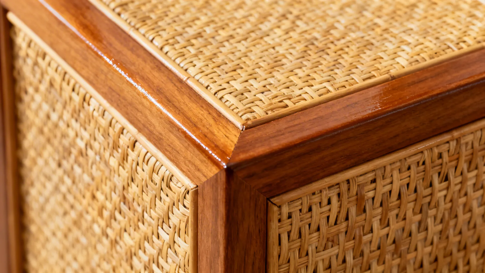 Macro of sealed handwoven cane inset within a warm wooden door frame.