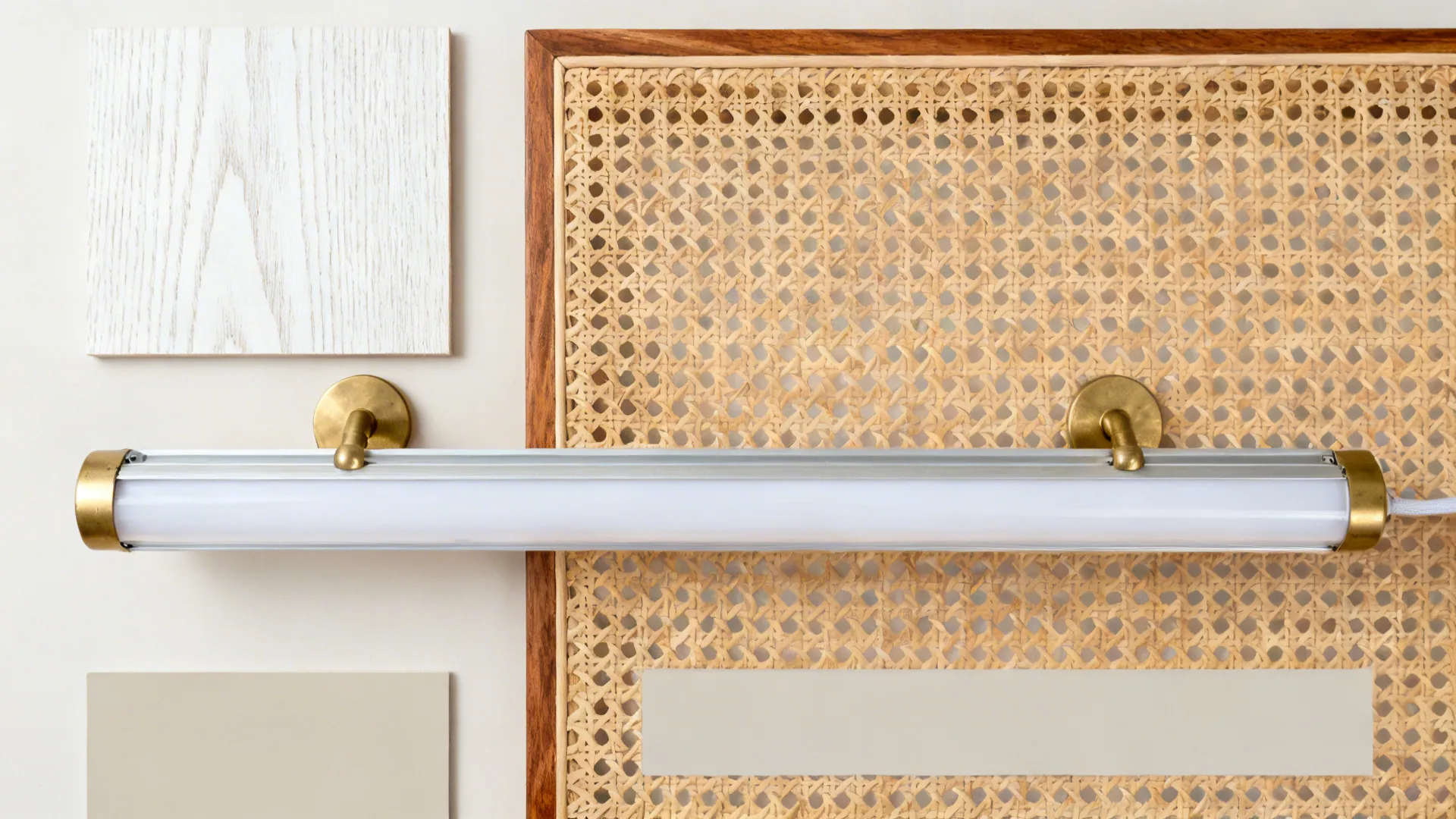 Flat lay of whitewashed ash veneer, natural cane, brushed brass, LED channel, and neutral paint chips.