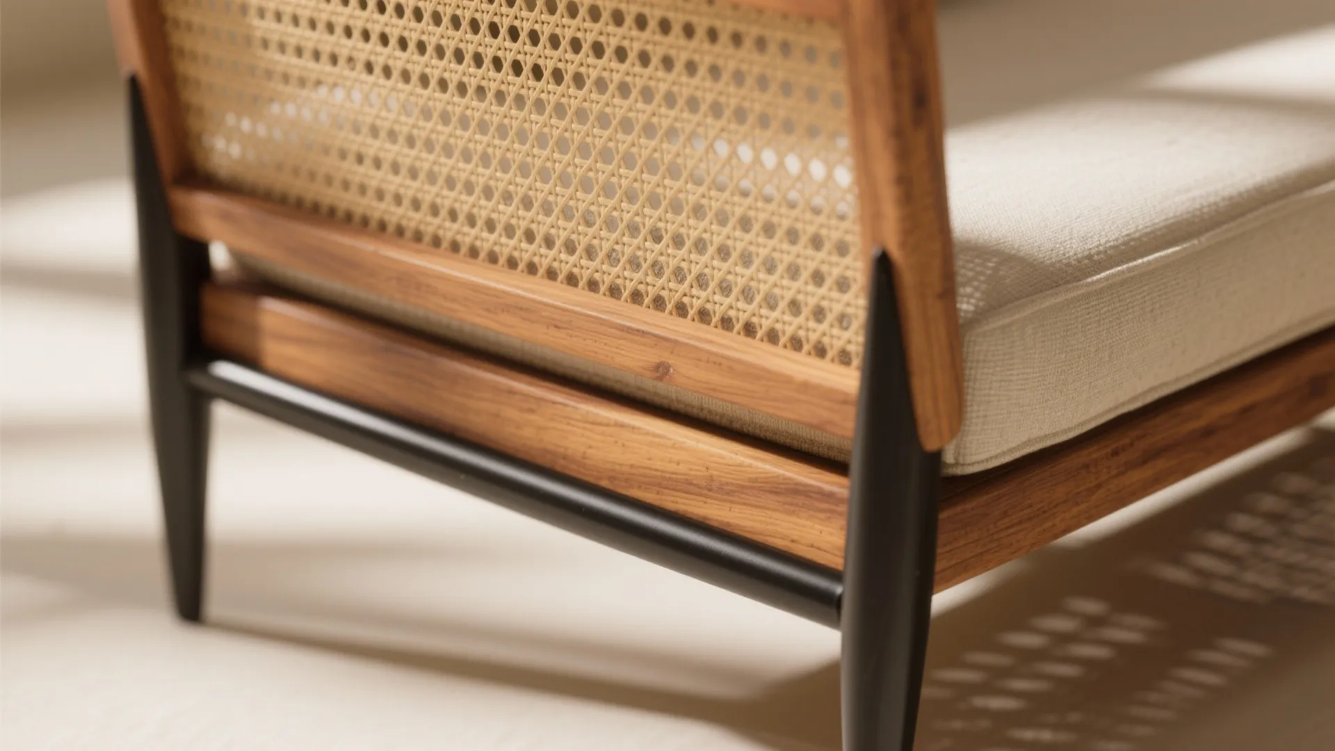 Close up of a wooden chair with woven backrest metal legs and a white fabric cushion