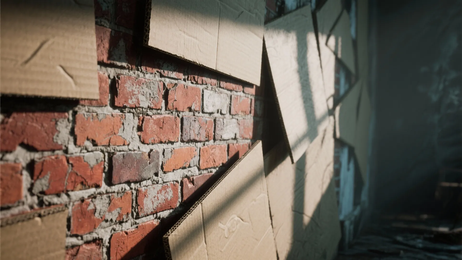 Red brick wall being covered with brown cardboard panels in a room with shadows and light