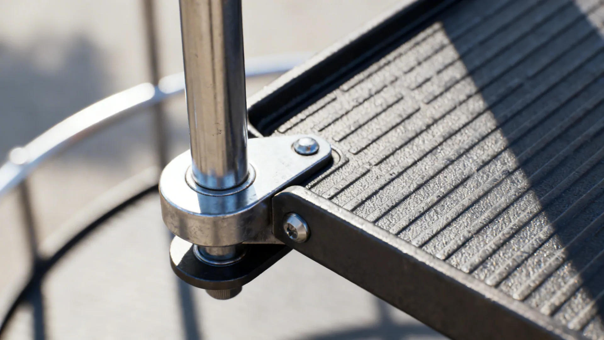 Macro of stainless carousel post and anti-slip tray hardware inside a corner cabinet.