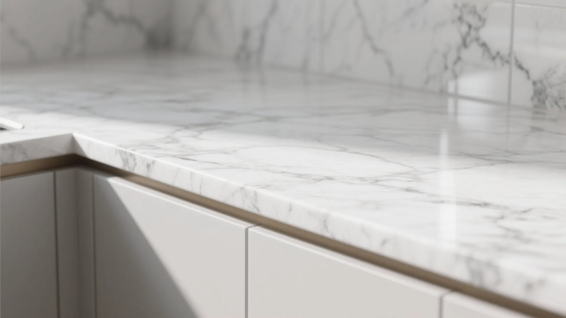 Close up of white marble kitchen countertop surface with clean white cabinets and soft light