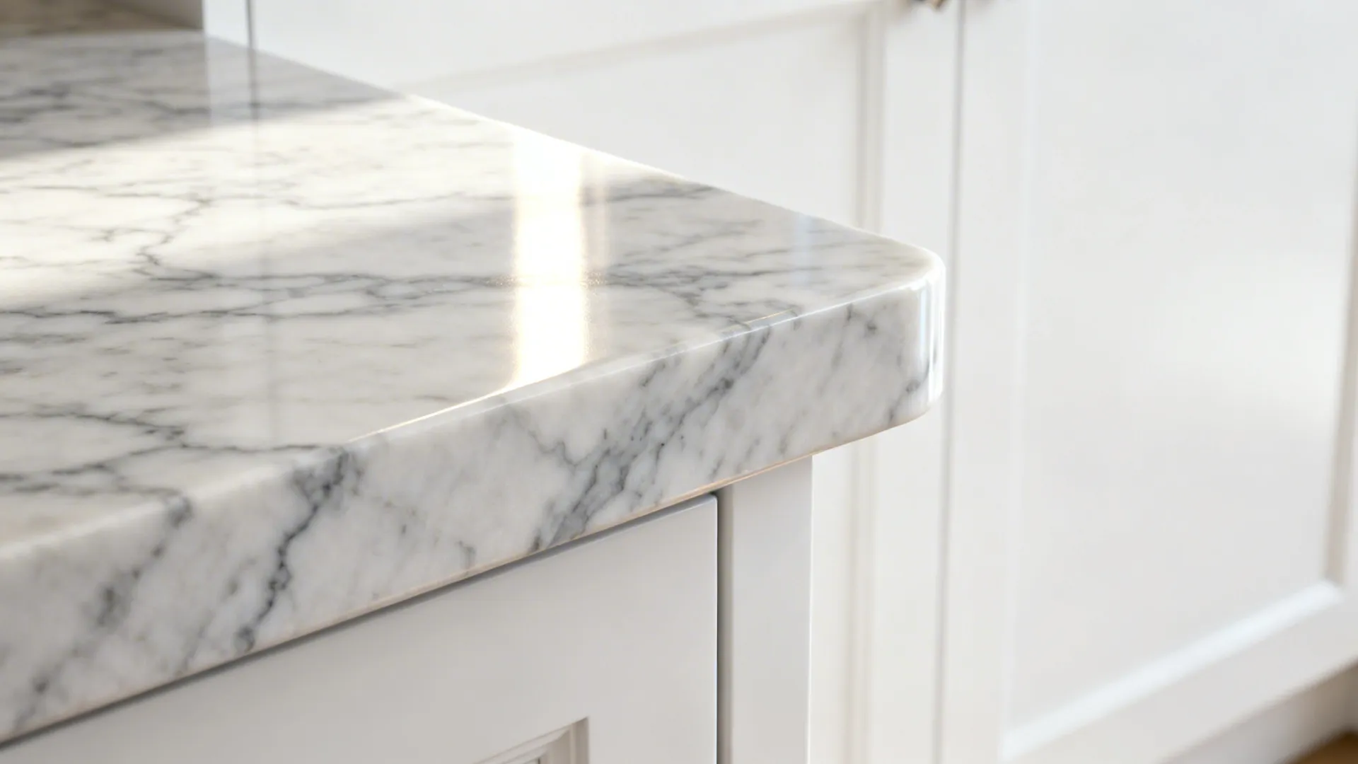 Close-up of Carrara marble countertop veins against white cabinet for an elegant look.
