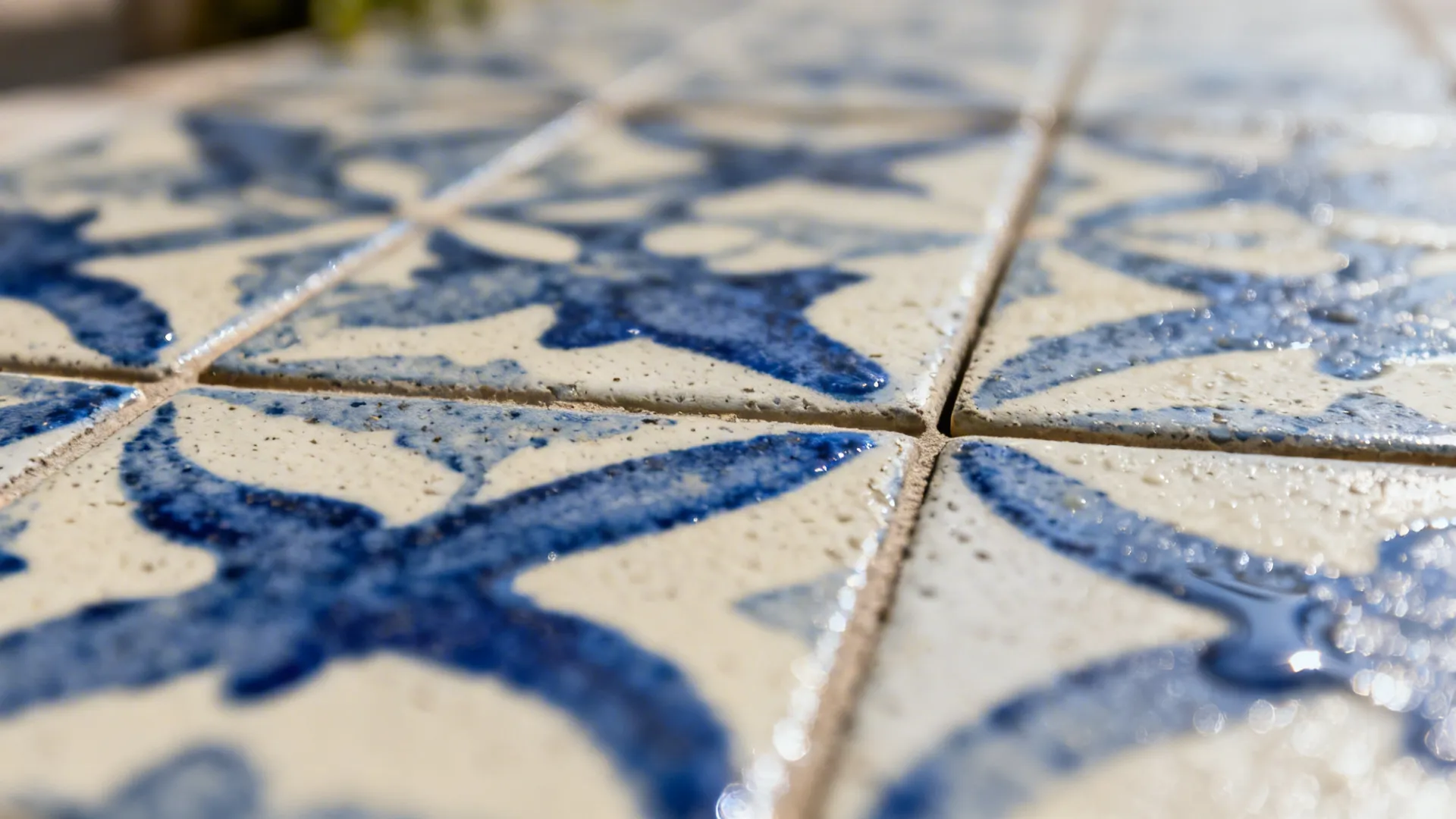 Close-up of blue-and-cream cement tile revealing rich pigment and artisanal texture.