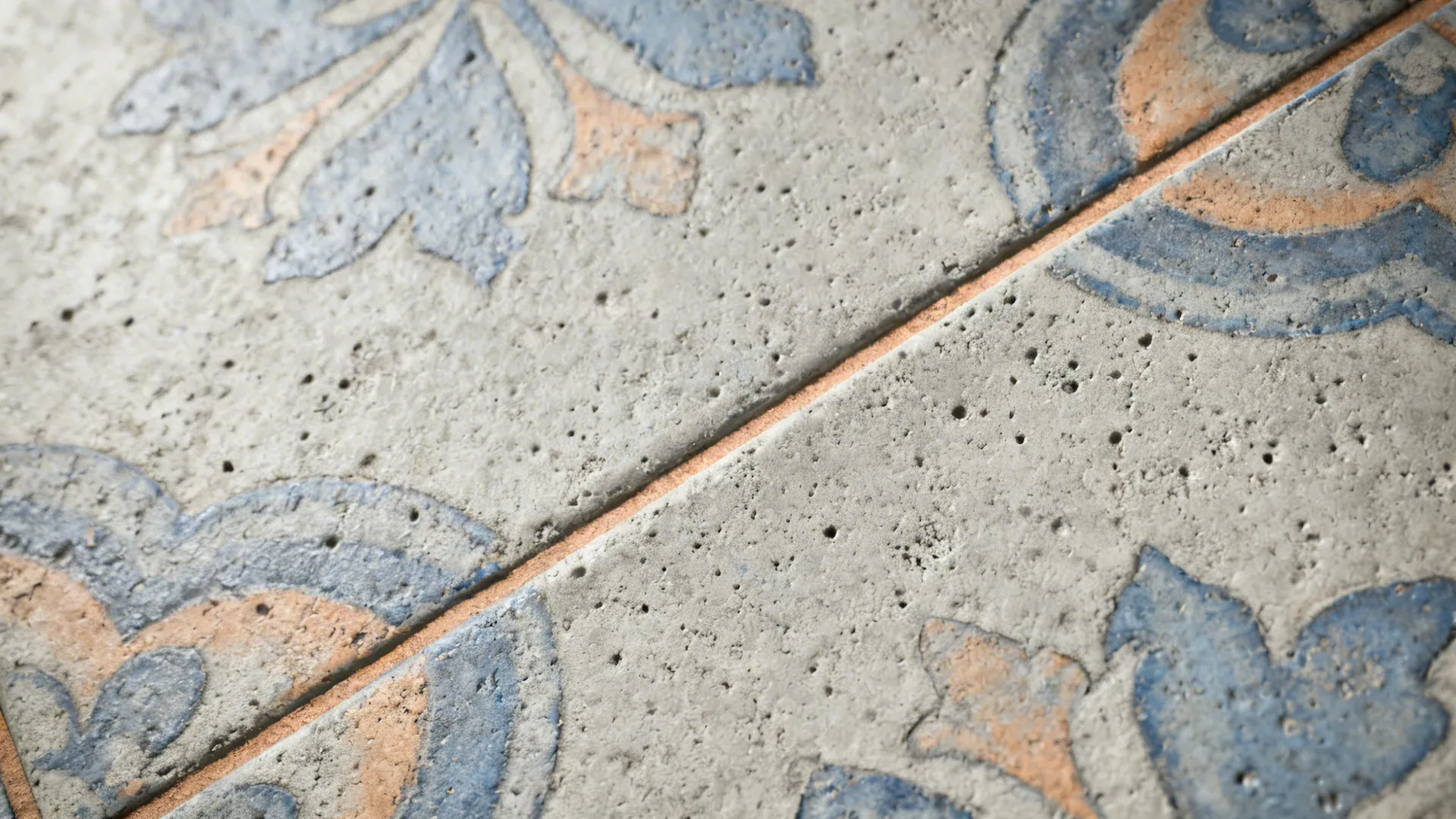 Close-up of matte encaustic cement tile with muted blue and gray pattern.
