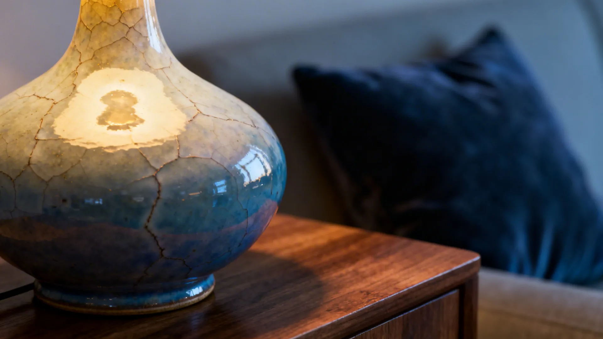 Macro of a hand-glazed sculptural ceramic lamp base showing glaze texture
