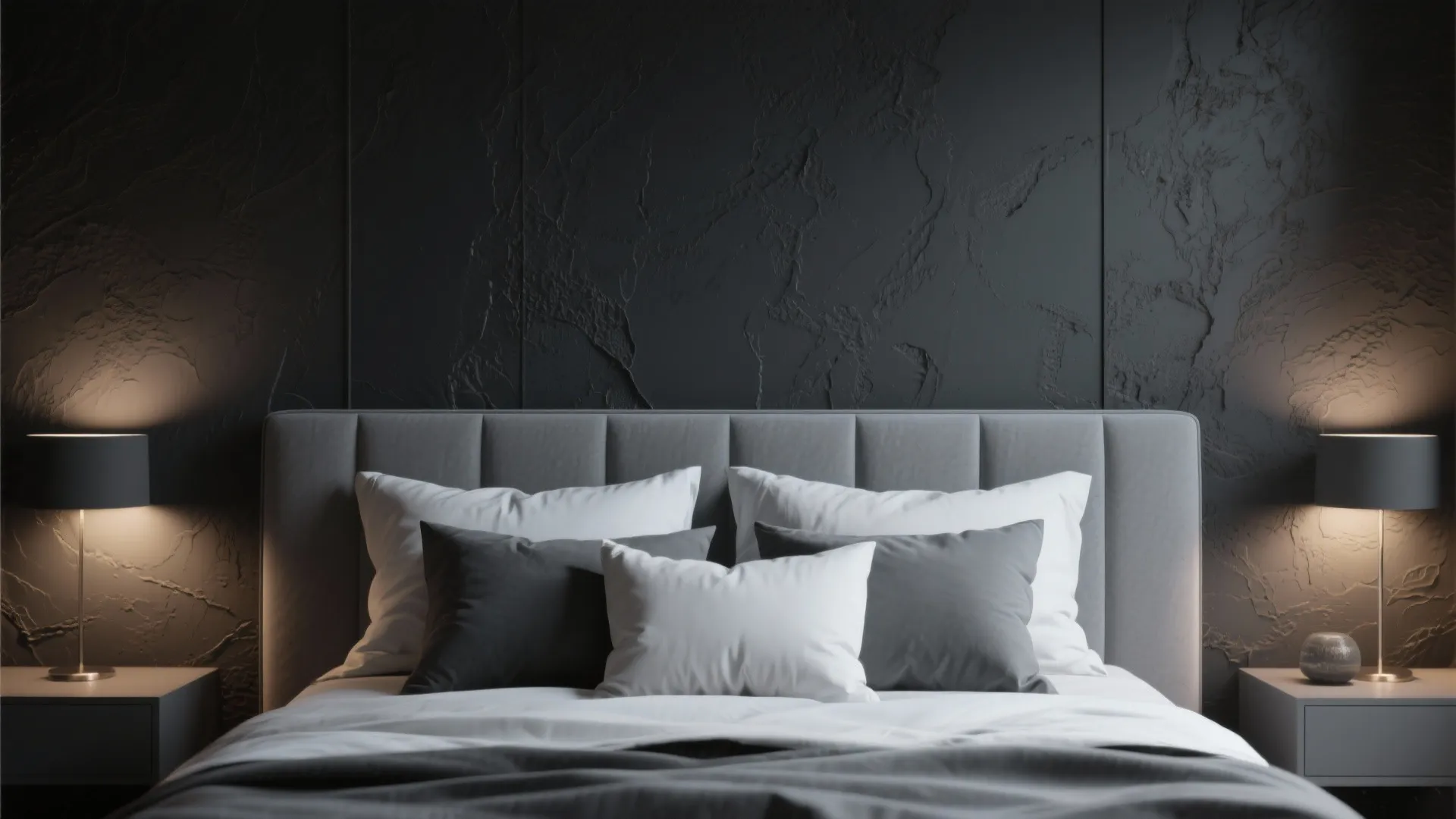 Bedroom with a charcoal accent wall behind a light gray bed, balanced lighting and layered pillows