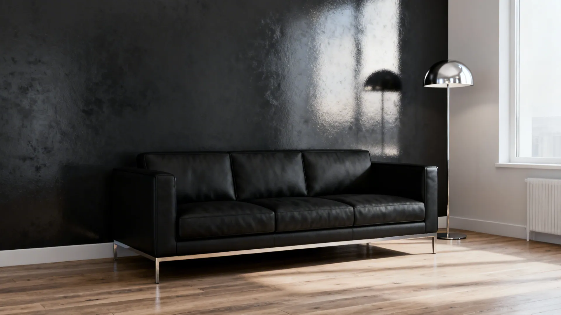 Living room with charcoal metallic accent wall behind a black sofa and silver lamp