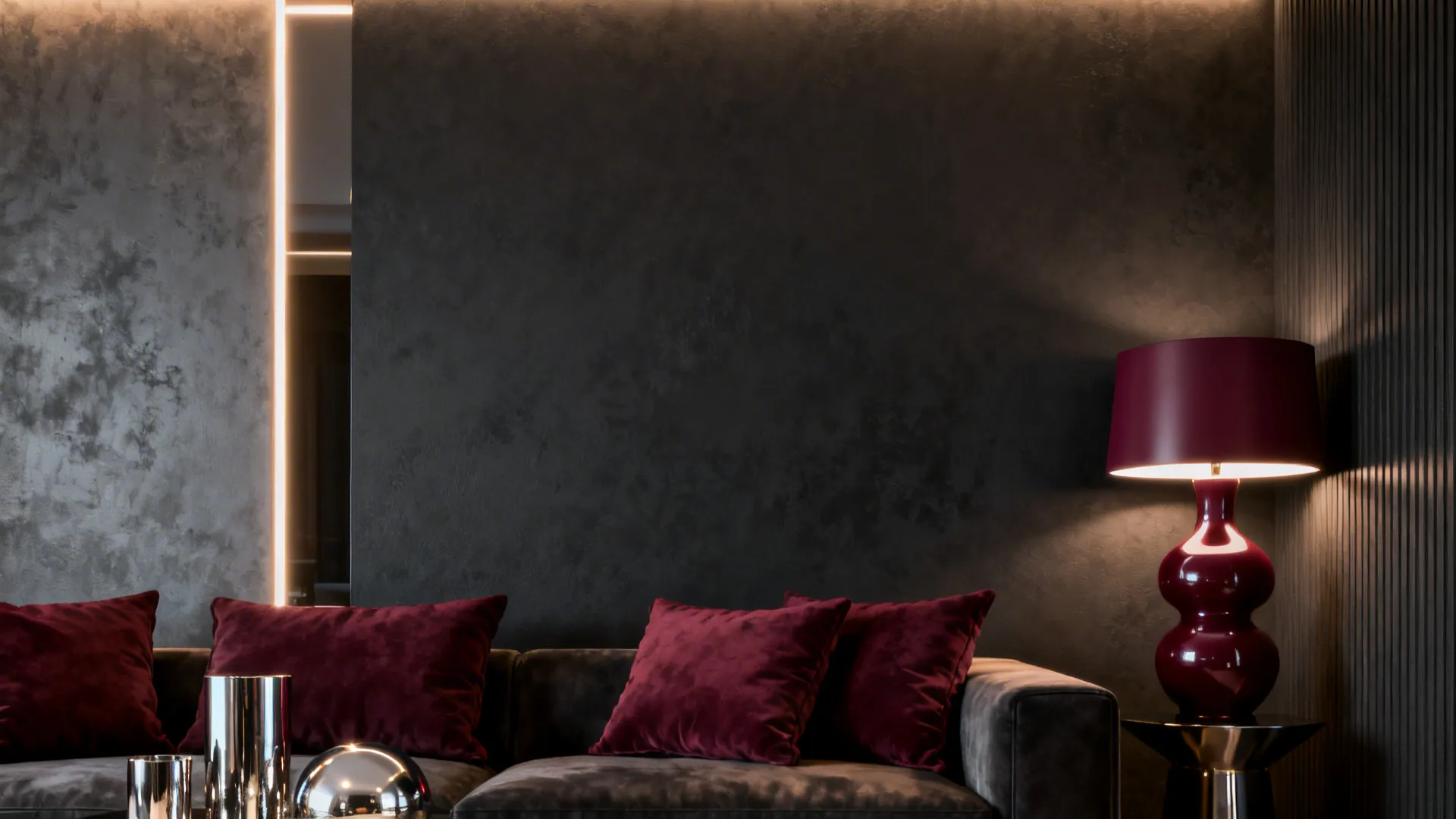 Living room with a charcoal accent wall and burgundy accents like cushions and a lamp