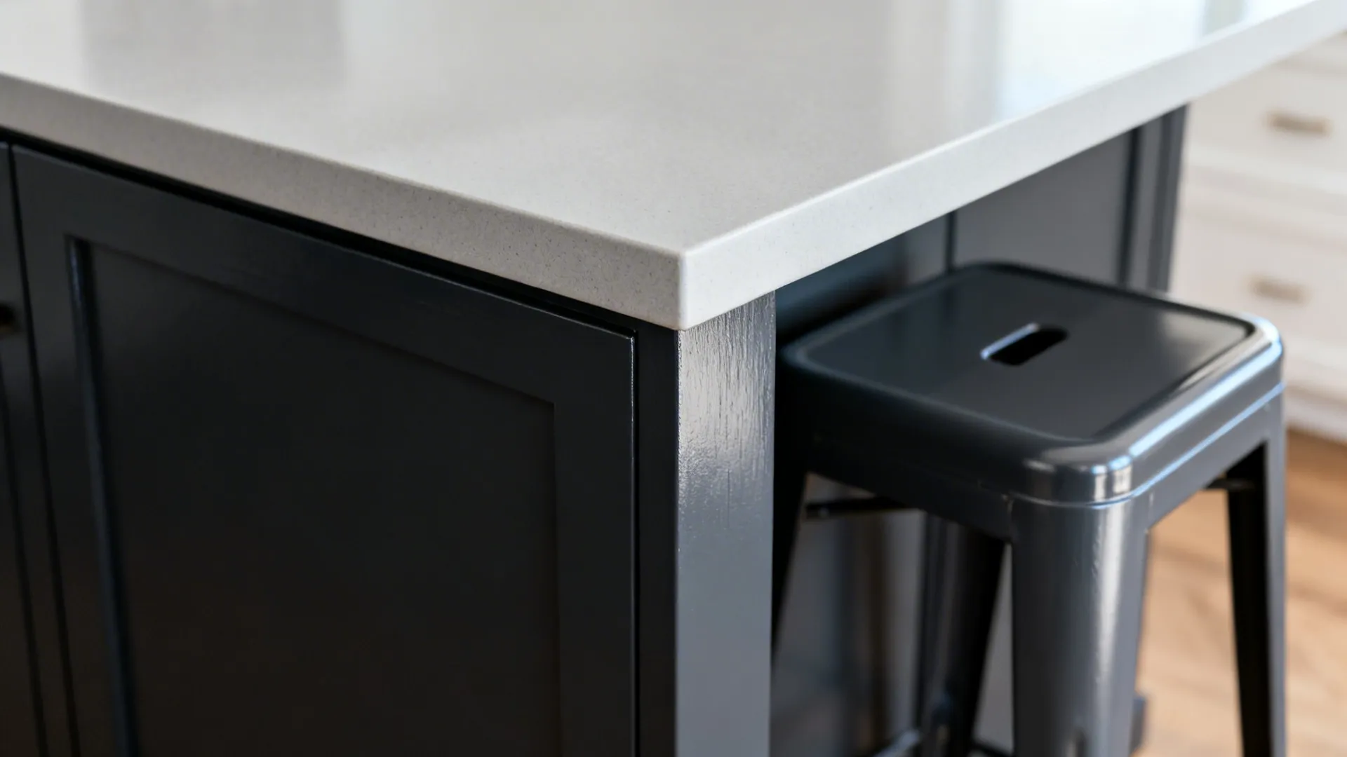 Macro of charcoal island finish with subtle higher gloss next to pale grey.