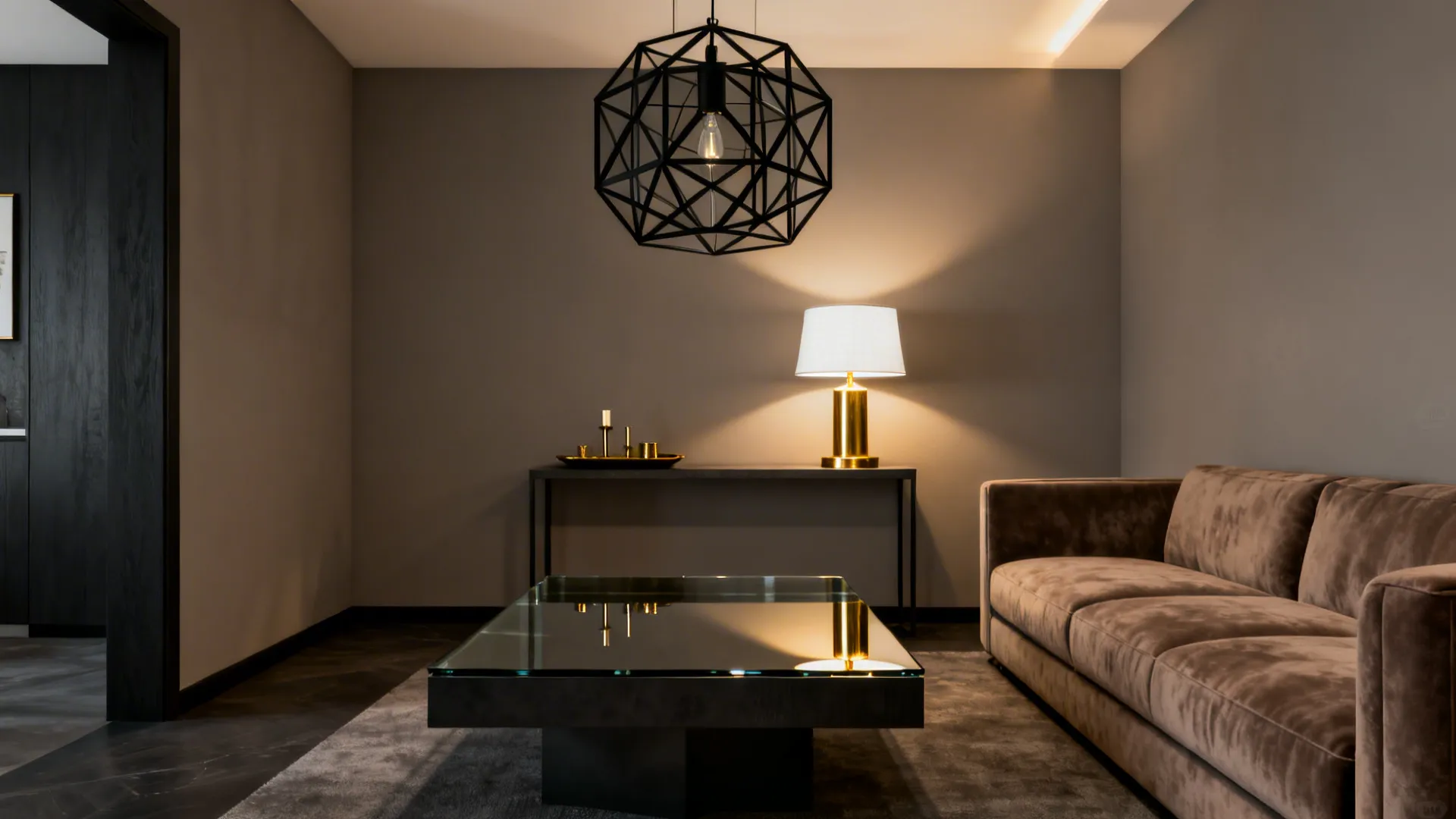 Small living space with charcoal coffee table and brass accents against a taupe-grey backdrop.