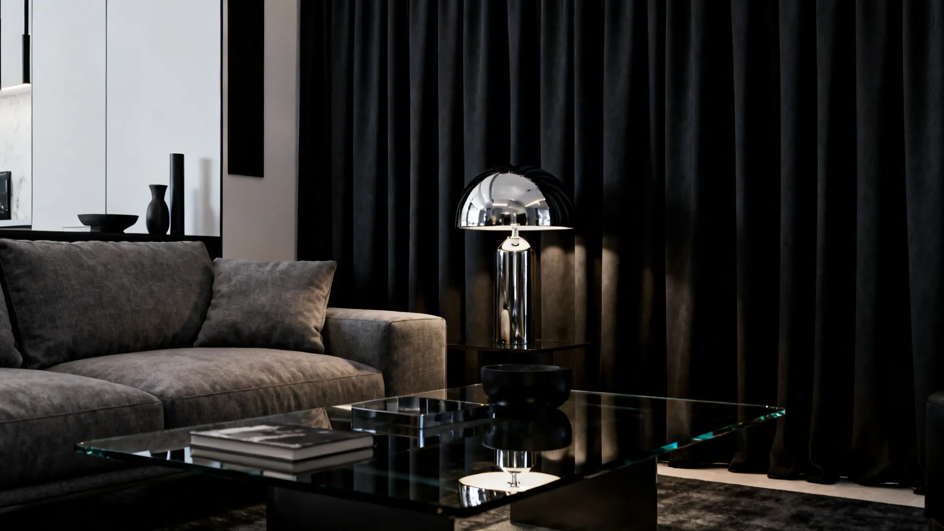 Grey couch with charcoal curtains and reflective accents in a minimalist room