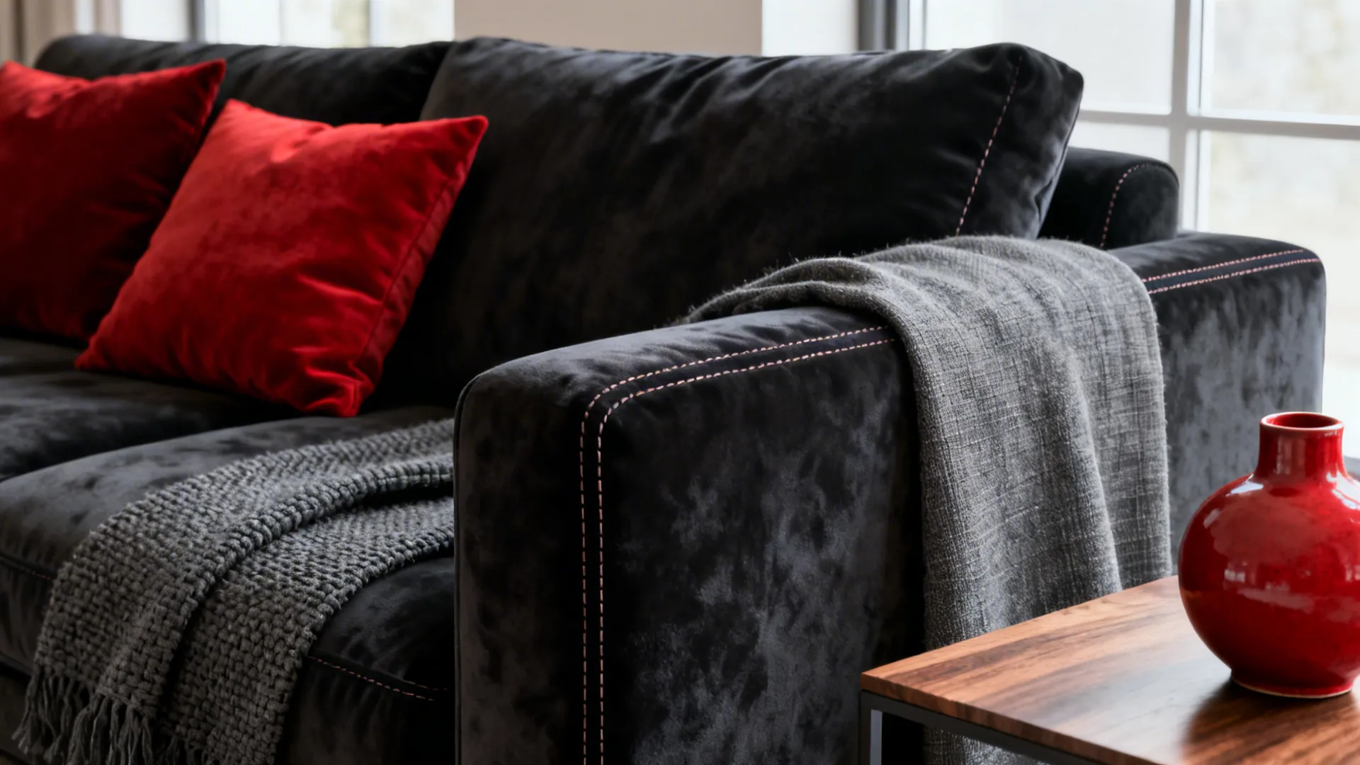 1. Anchor With a Deep Gray Sofa and Red Accents