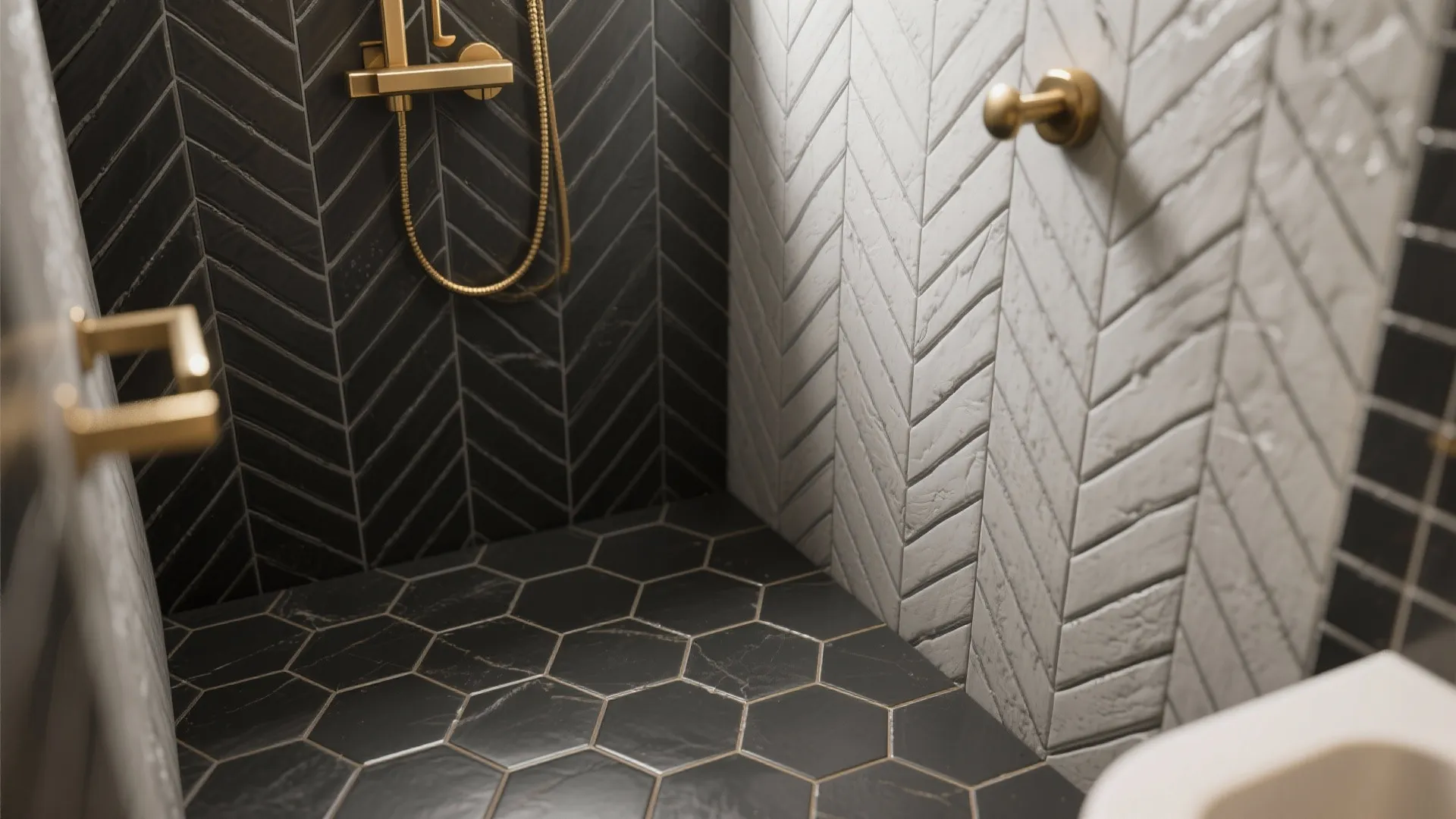 Modern shower corner with black and white patterned wall tiles and gold metal shower head