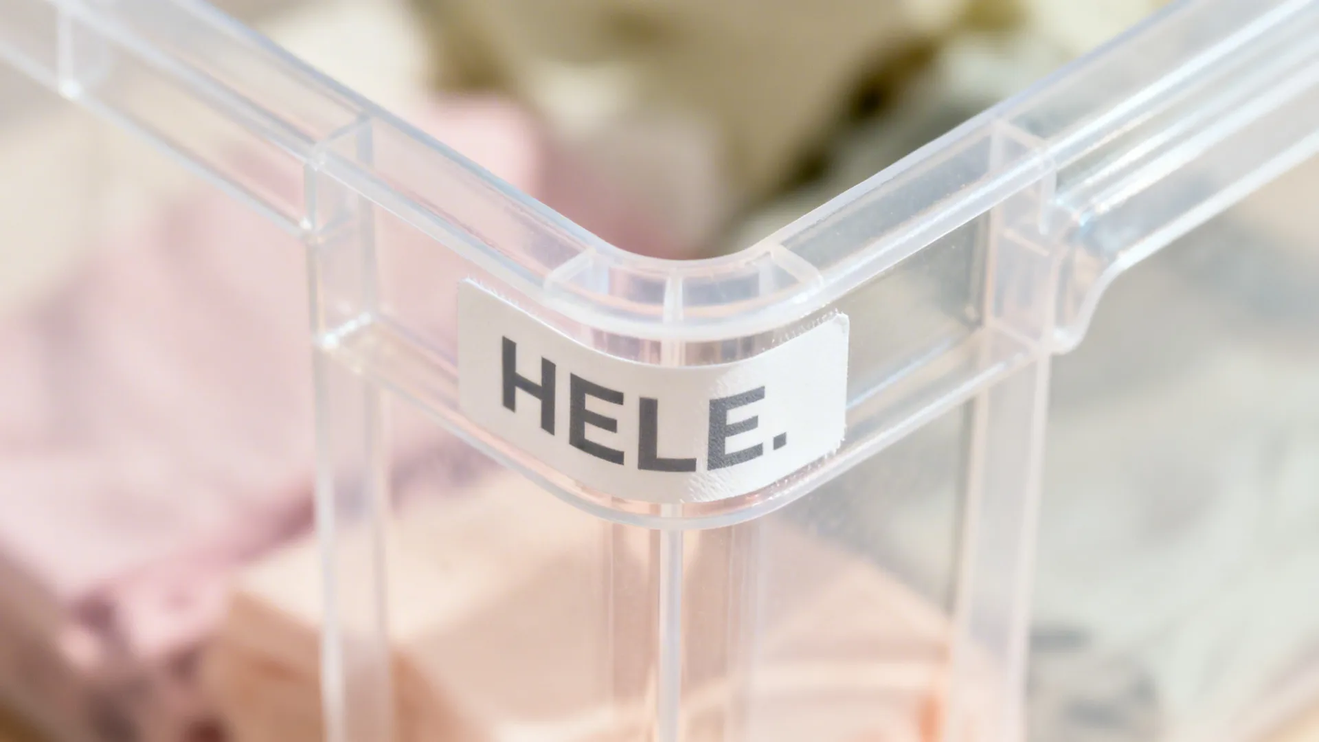 Macro of a stackable clear bin with a bold label applied on the side.