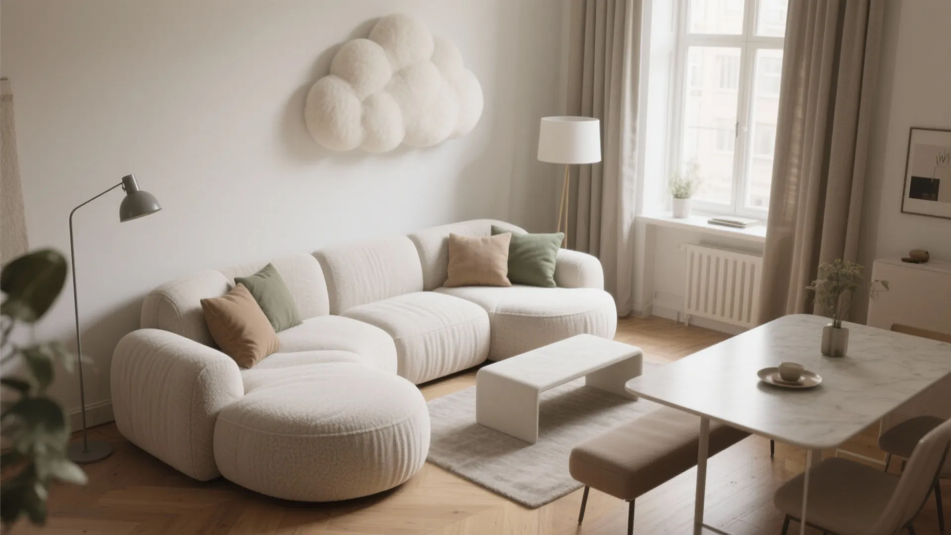 White curved sofa with green pillows near cloud wall art and marble dining room table